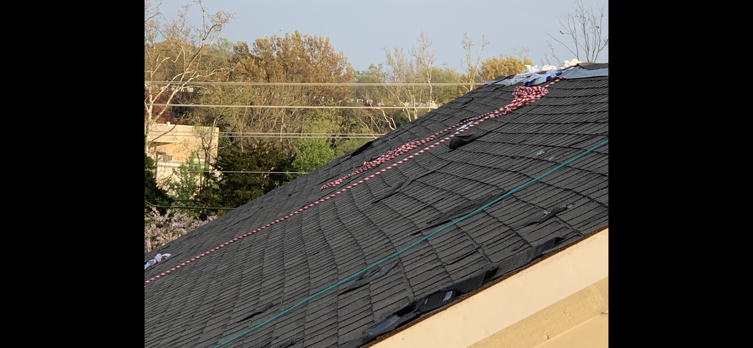This is a view of darker shingles being installed.