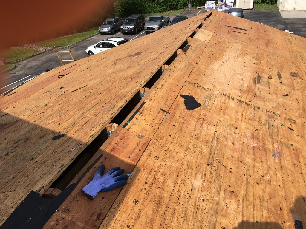 This is a view of the roof deck at the ridge shingles and felt have been removed. 
