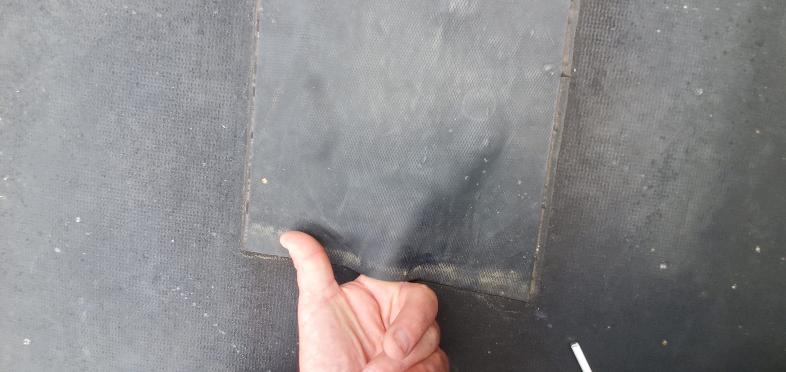 This is an patch on an black EPDM roof that is no longer sealed. 
