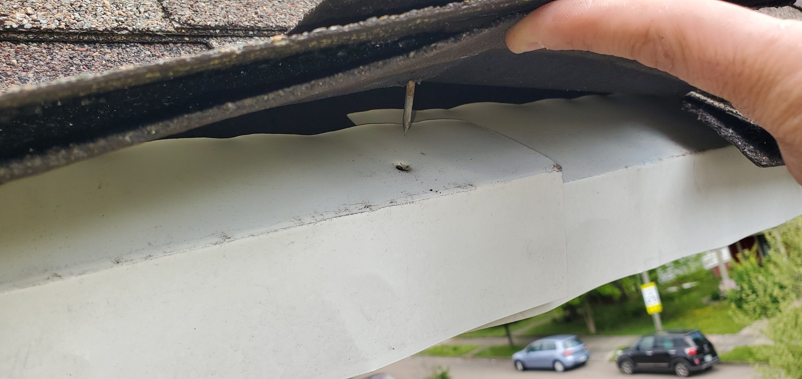 This is a view of white drip edge that was not installed properly. 
