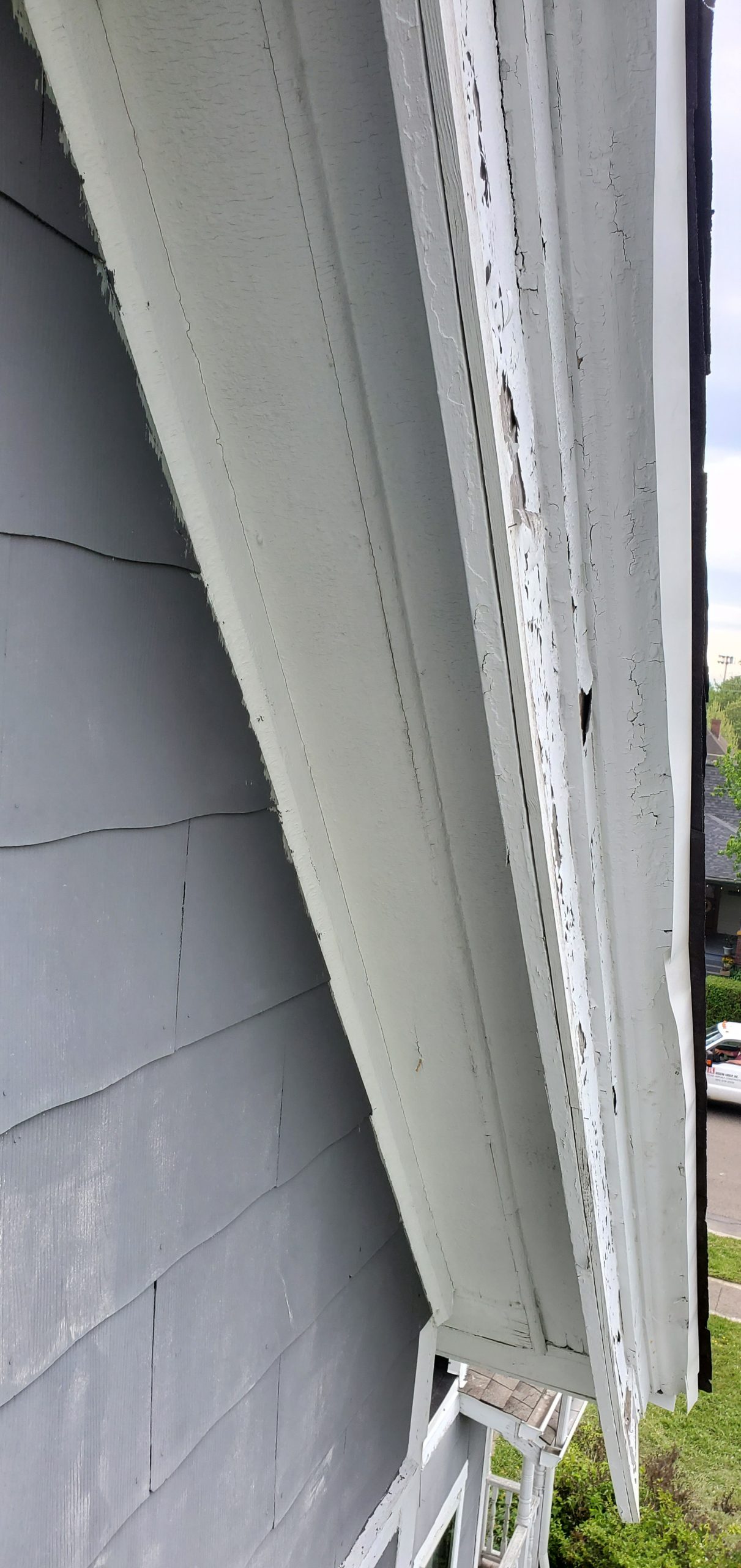 A view of white drip edge that was not installed correctly. 
