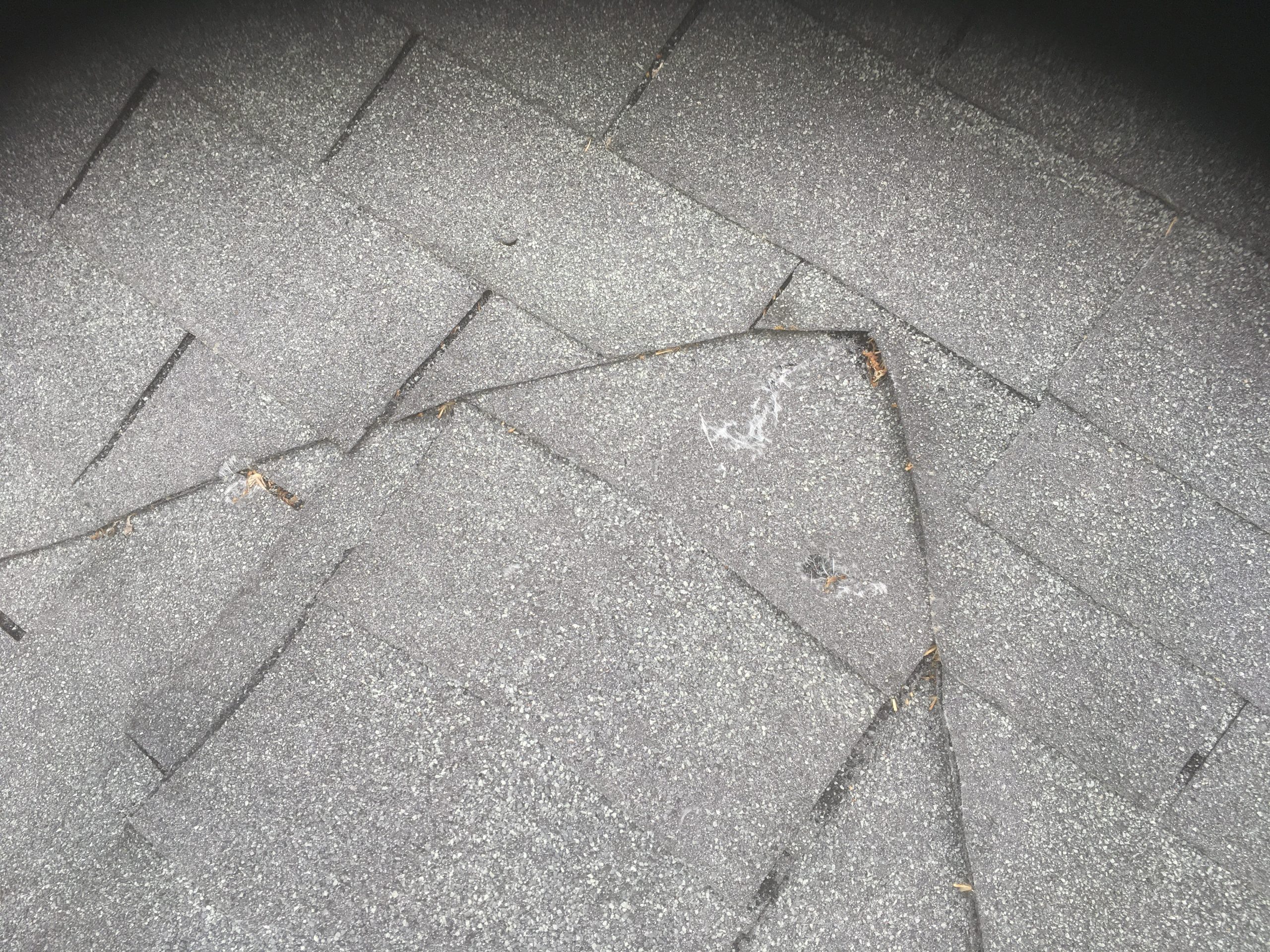 This is a picture of gray shingles that was repaired incorrectly.