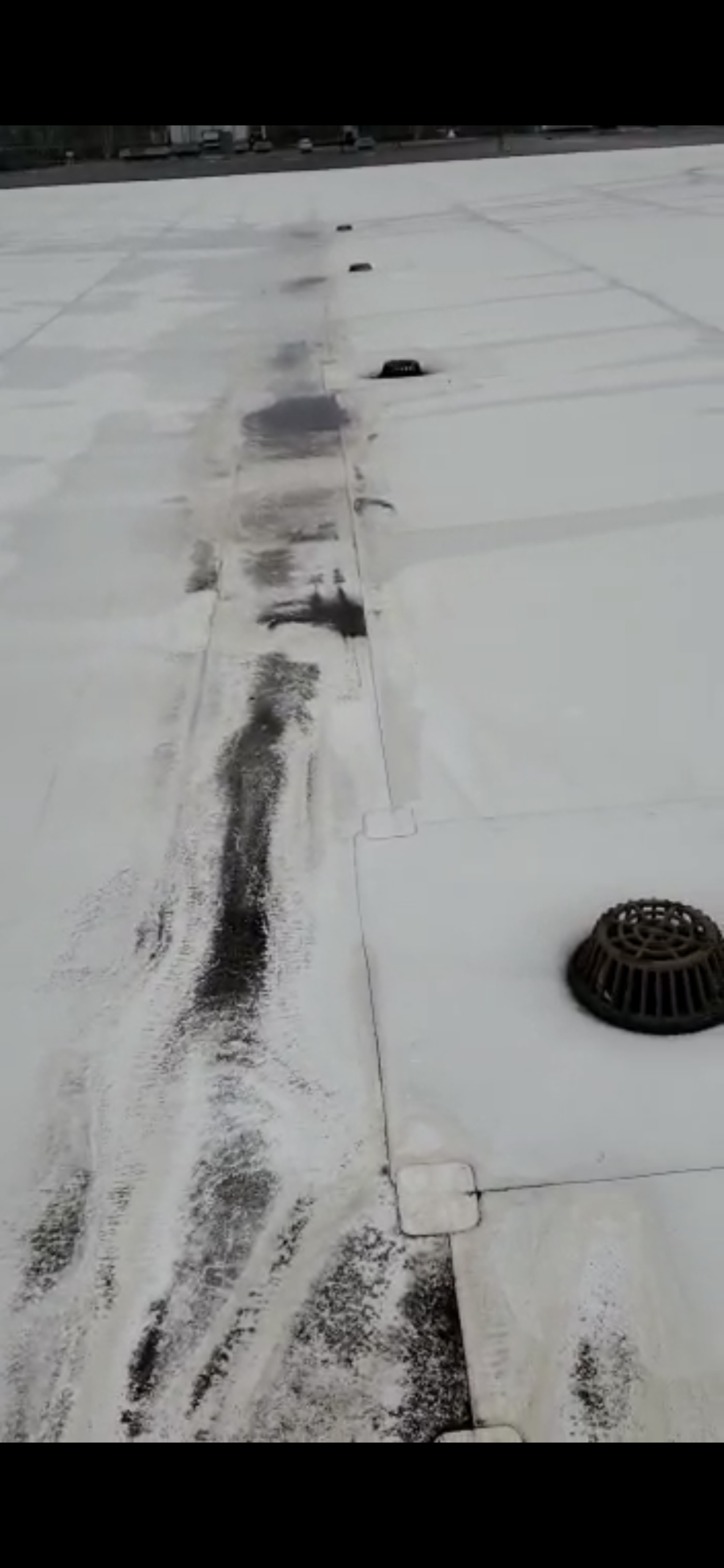 This is an image of white flat roof indicating the sloping is not correct for proper drainage. 