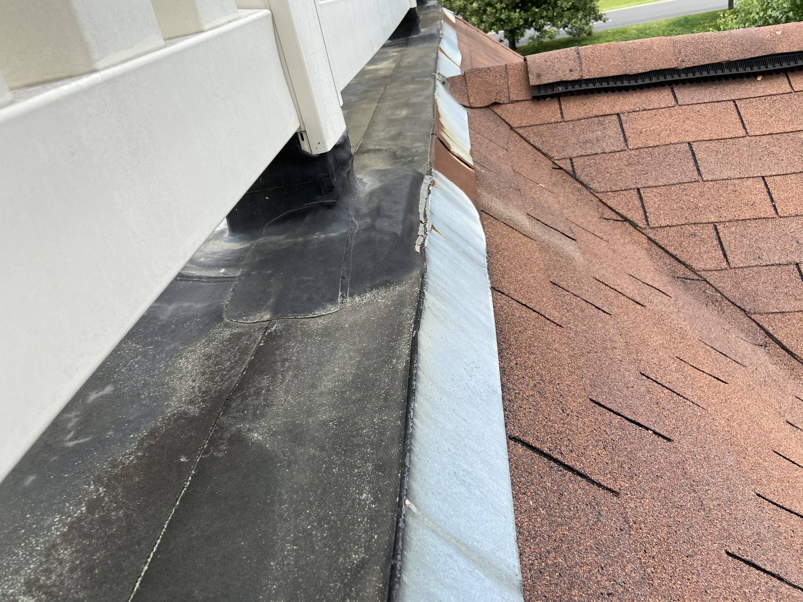 This is an up close image of the white rail on the flat roof. 