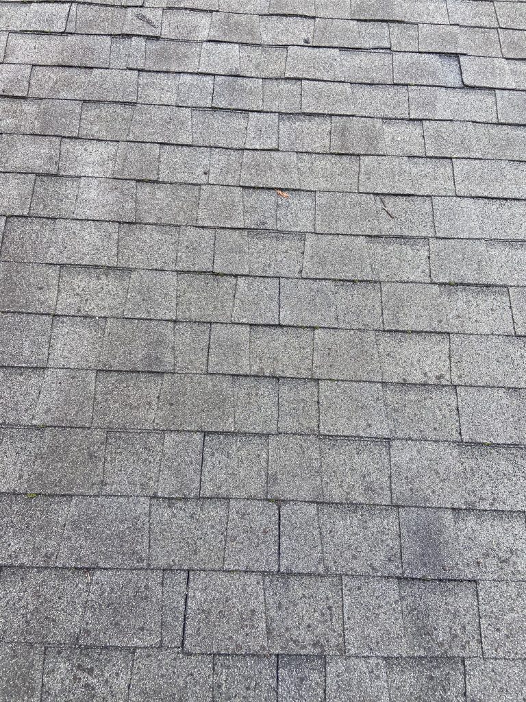 This is an image of dimensional shingles that have damage. 