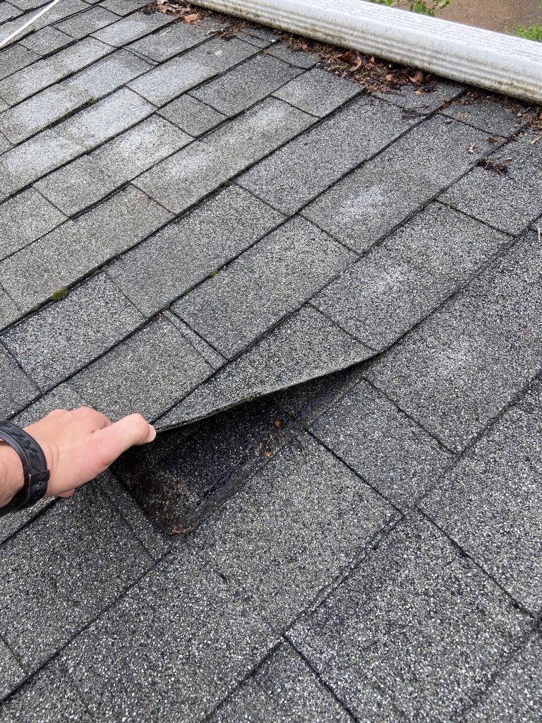 This is the shingle being lifted to show the nails are bad. 