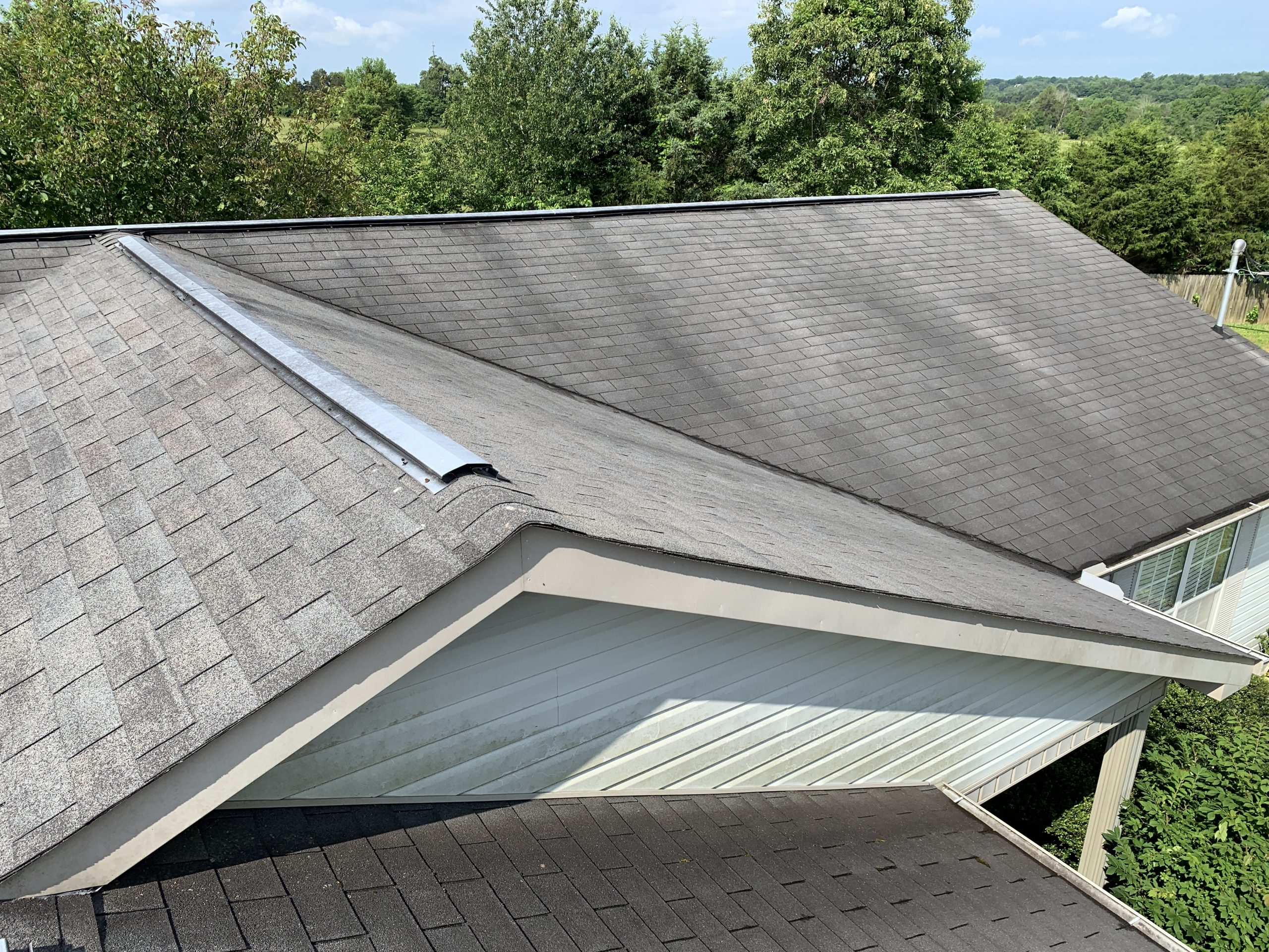 This is the view of the roof with gray shingles showing the ridge of the roof.  