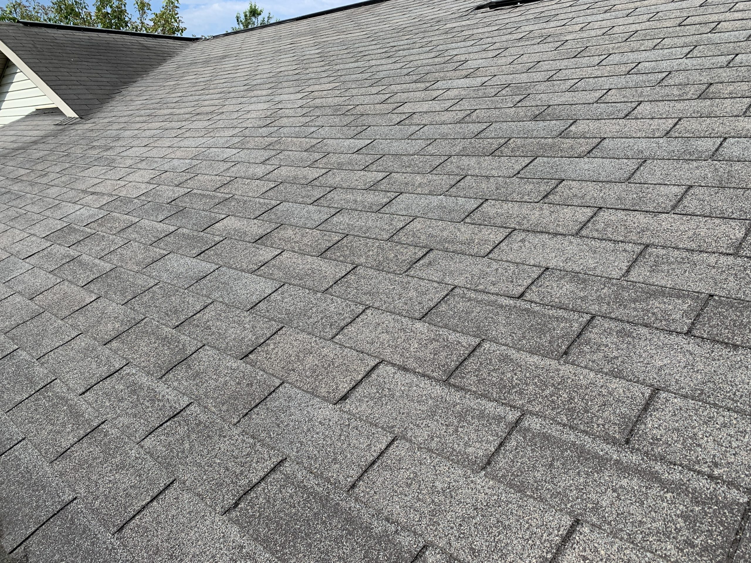 This is a view of a slope of the roof with gray shingles. 