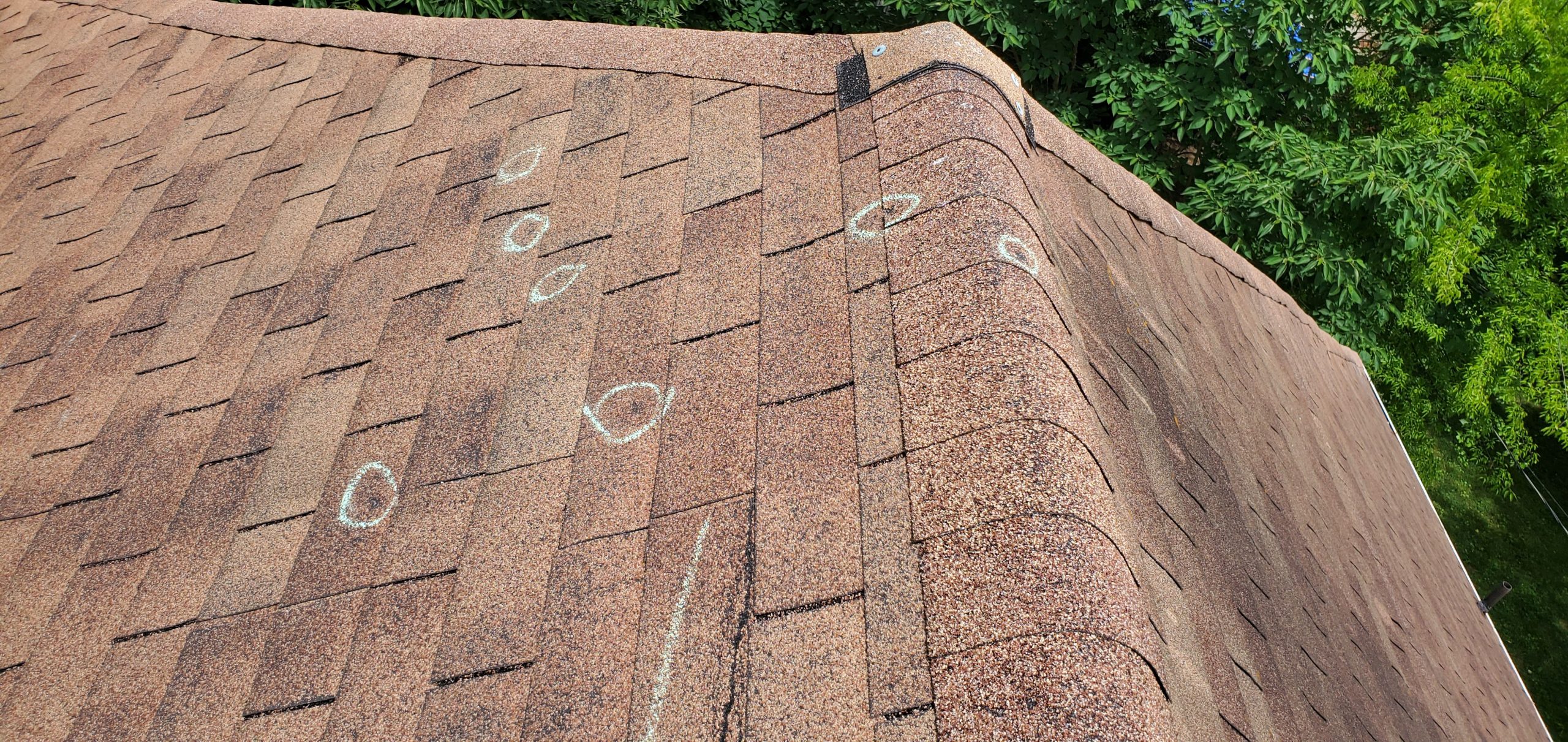 this is a picture of chalk marks on a roof that are circular showing hail damages to a roof in knoxville tn
