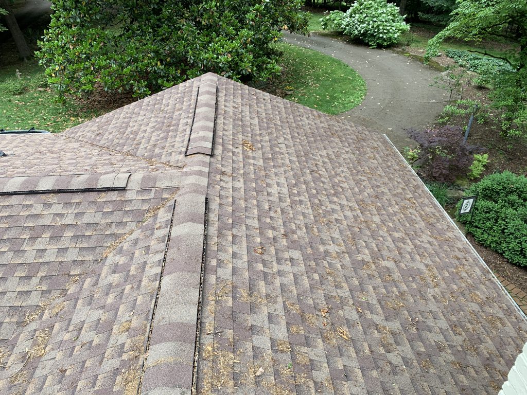 this is a picture of weathered wood colored shingles on a new roof