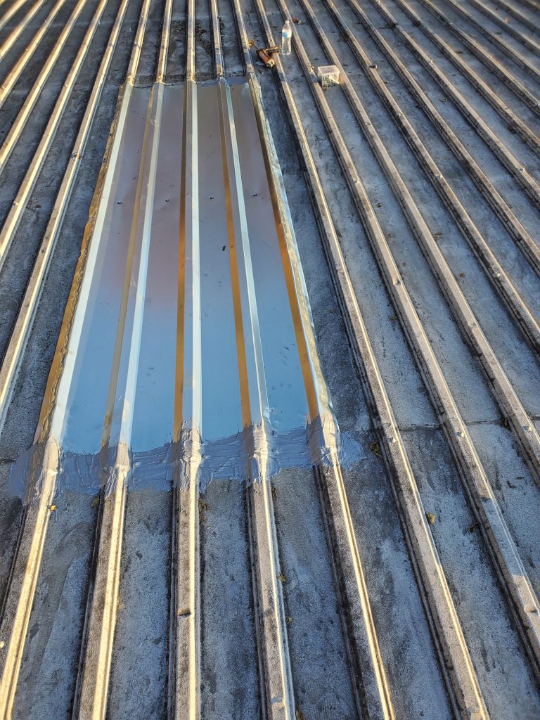 This is a view of the skylight on a metal roof sealed over with Aldo 385. 