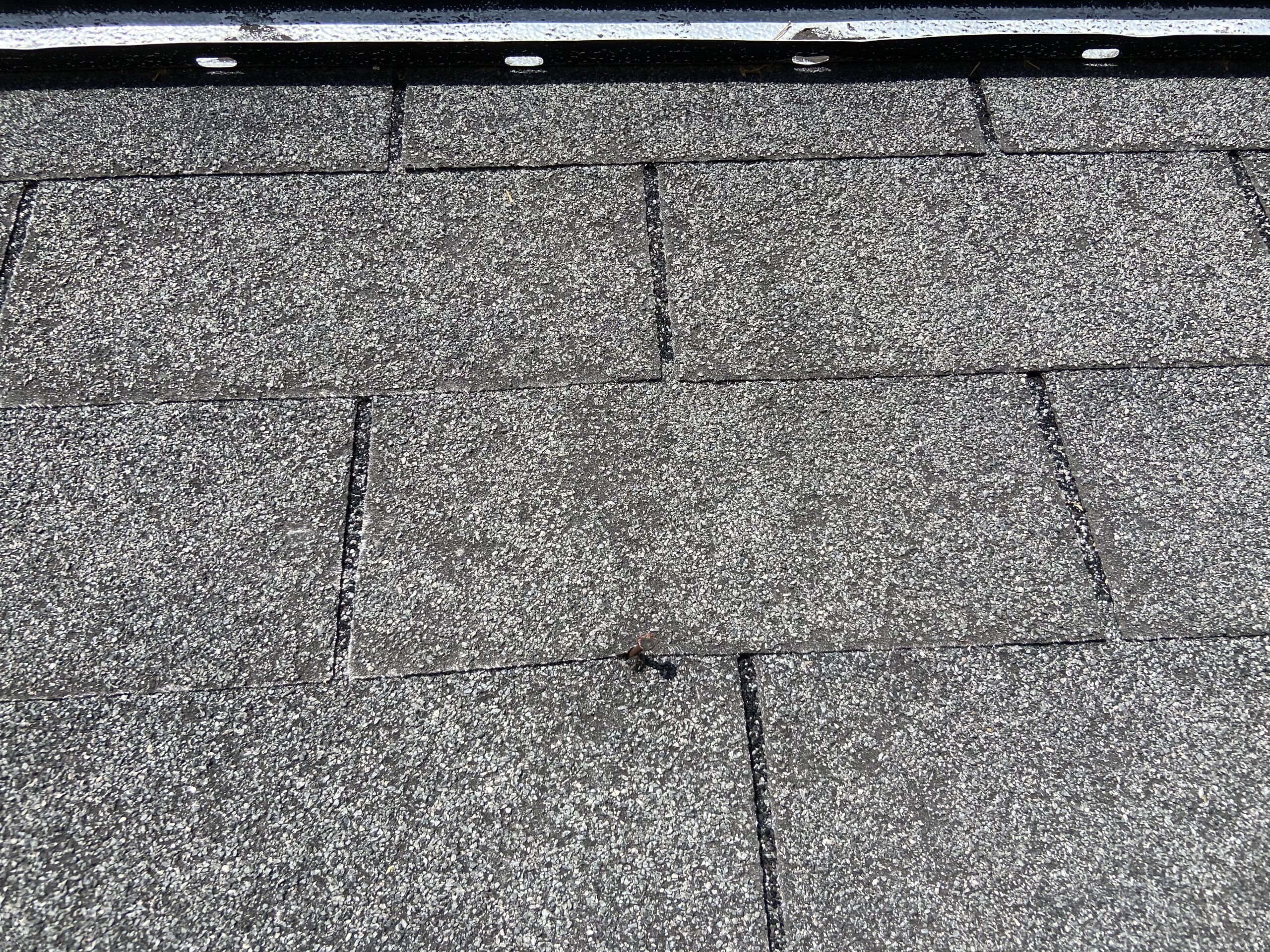 this is a picture os shingles that are worn out with most of the granules missing