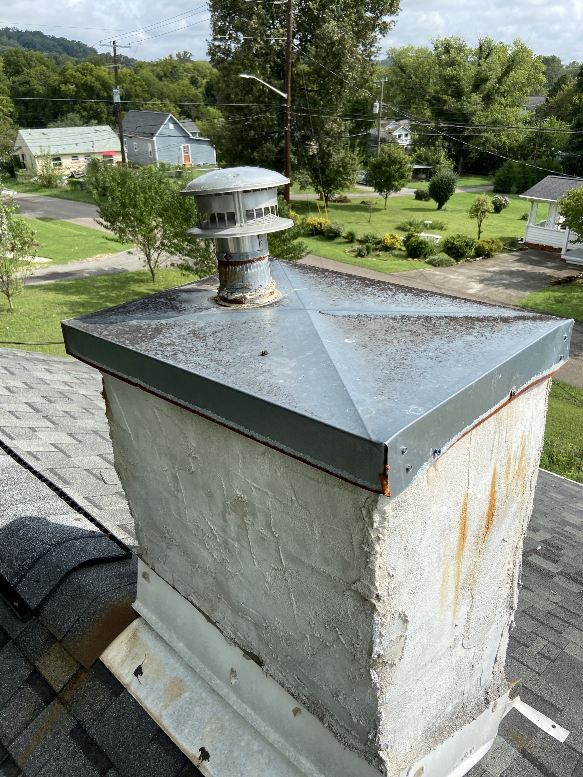 Rusty Metal chimney cap that needs to be replaced