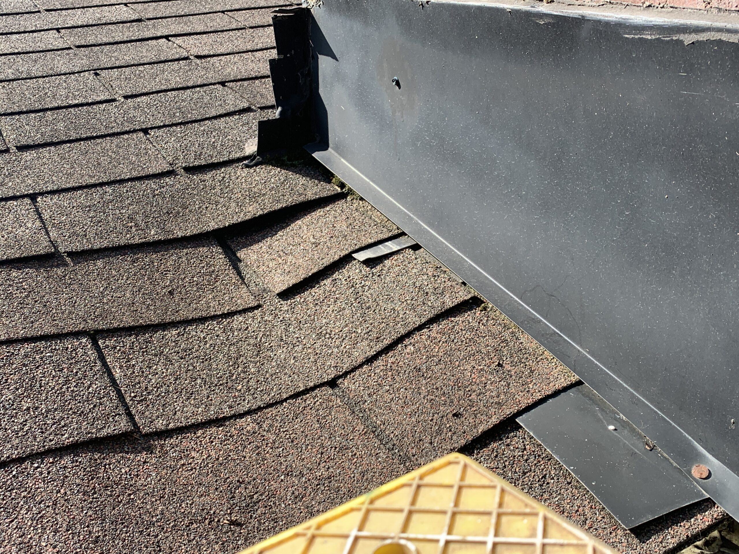 Residential shingle roof with leaking chimney and soffit sagging ...