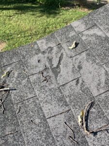 Damaged shingles on residential home