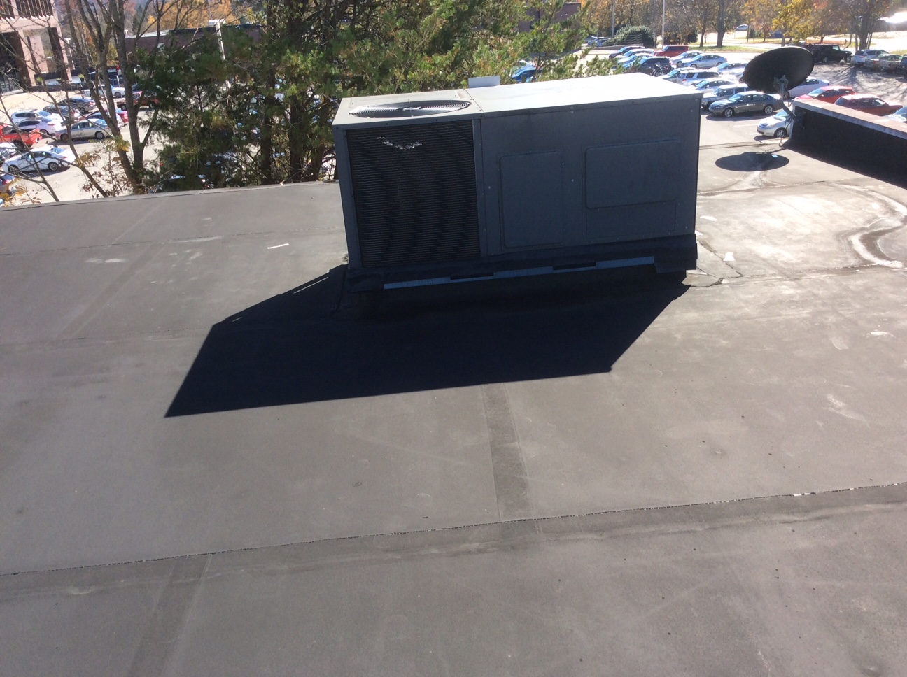 This is a view of a commercial flat roof with an AC Unit. 