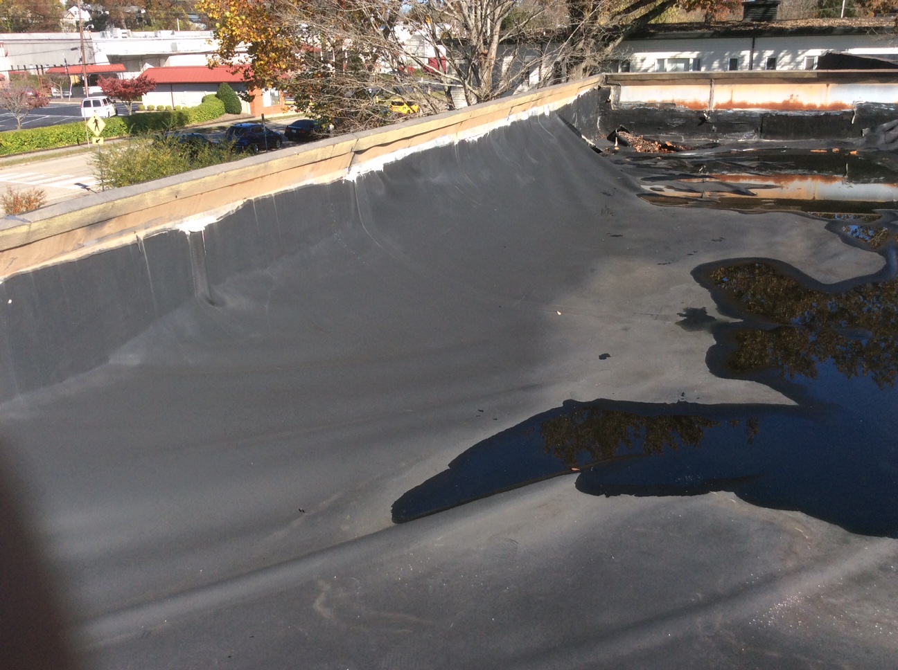 This is a view of a commercial flat roof with ponding water. 