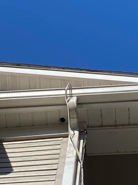 This is white soffit at the gutters of the apartment complex building. 