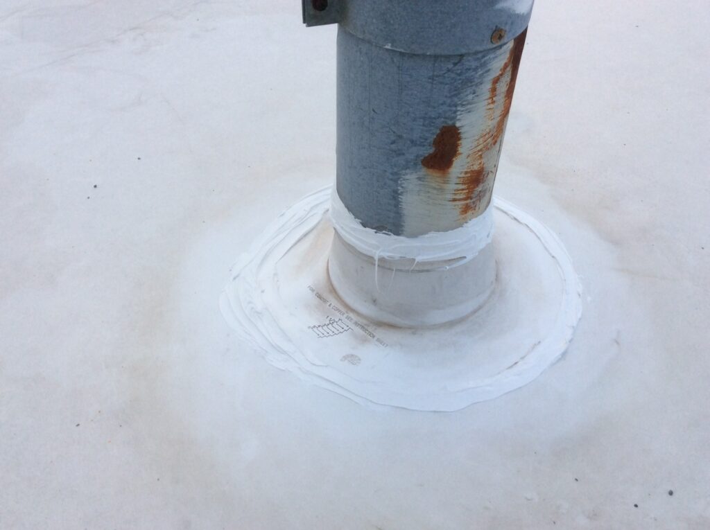 This is a view of a gas vent on a white TPO roof.