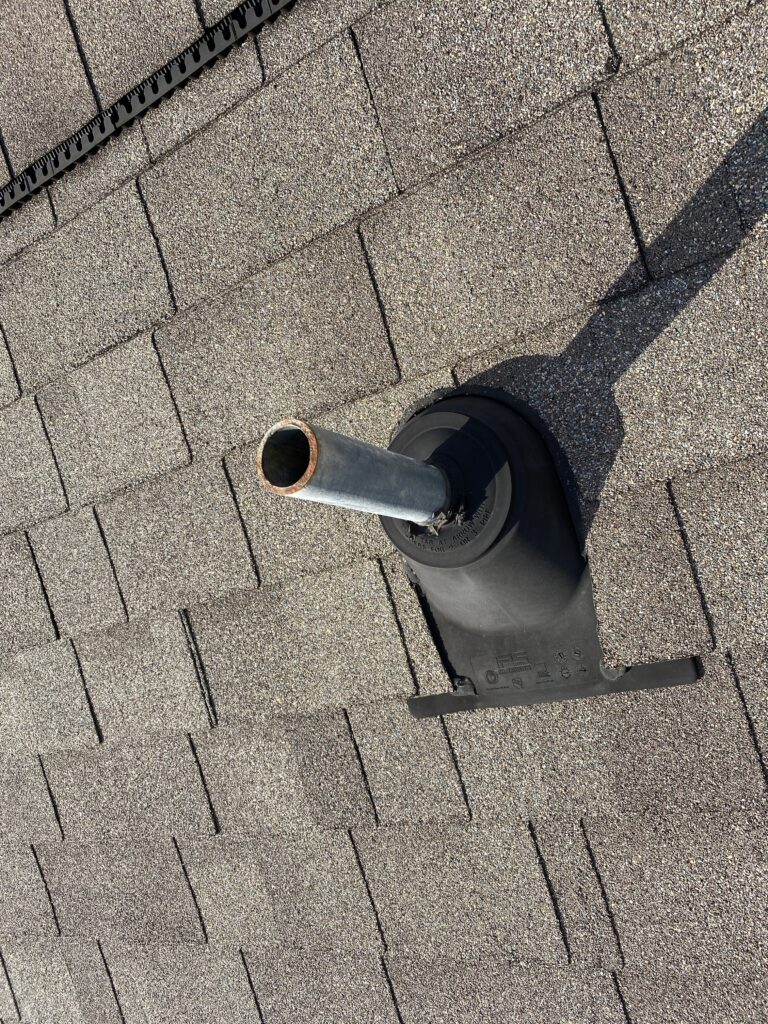 This is a picture of a brown roof with a pipe boot that needs some work