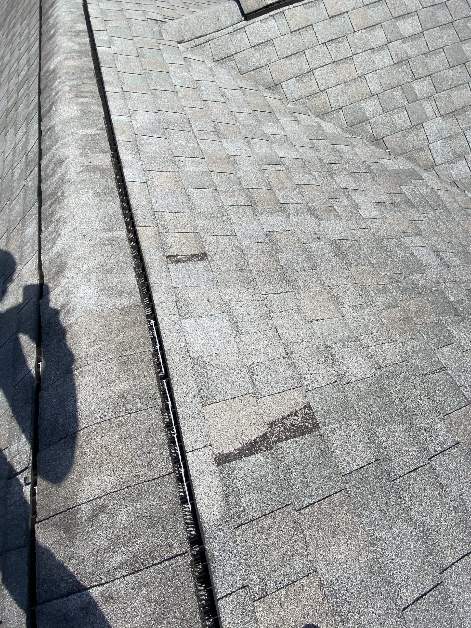 This is a picture of an old gray roof with missing shingles
