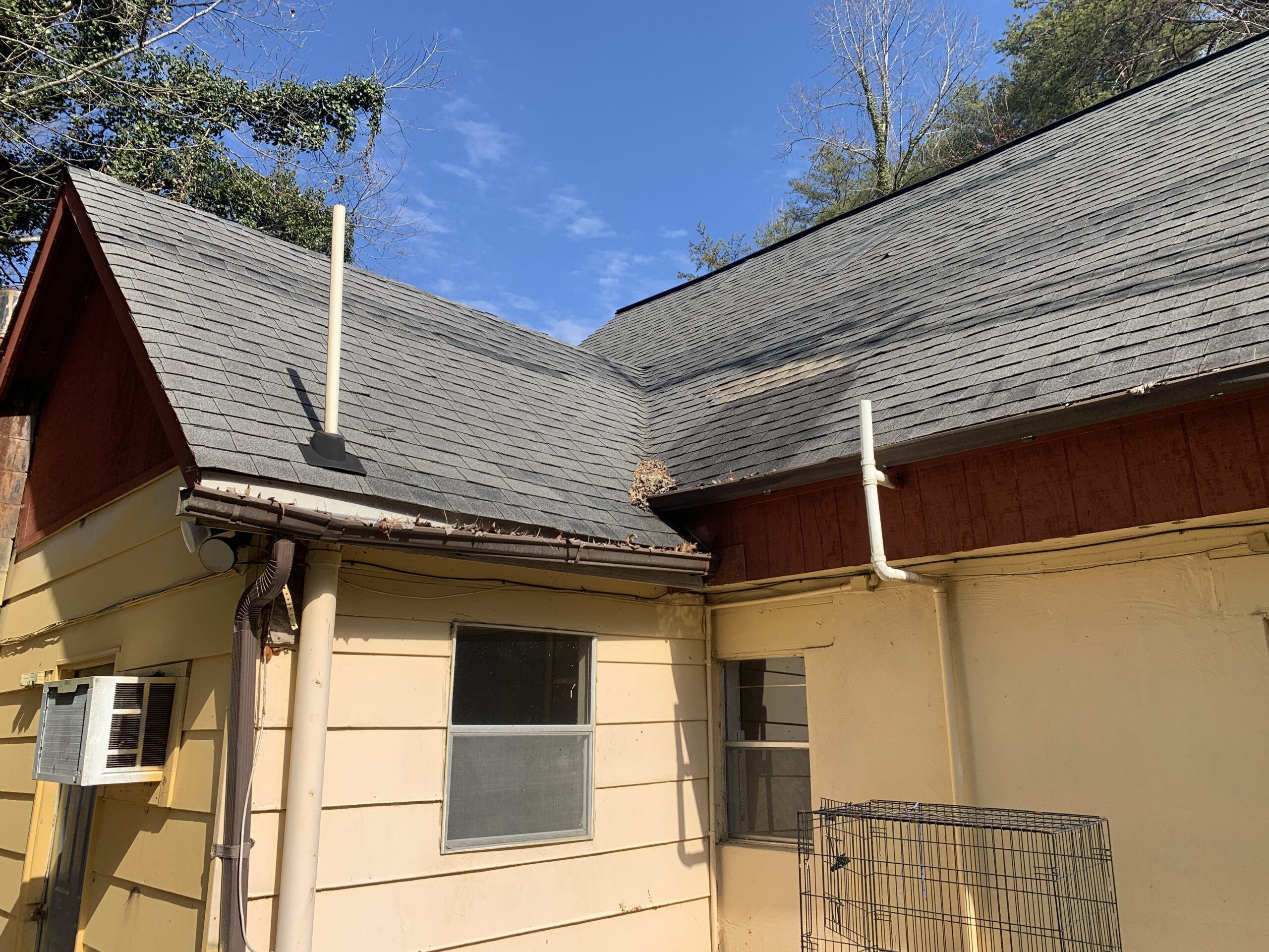 Some areas of this architectural shingle roof have been visibly repaired or replaced