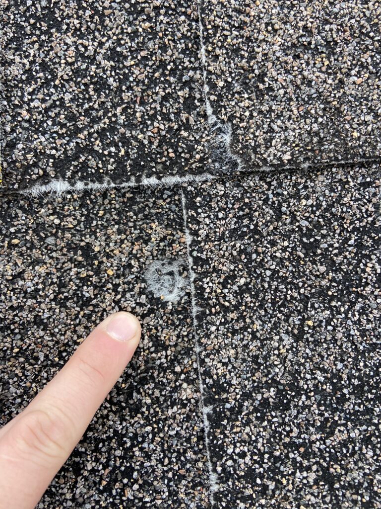 This is a picture of hail damage on a shingle