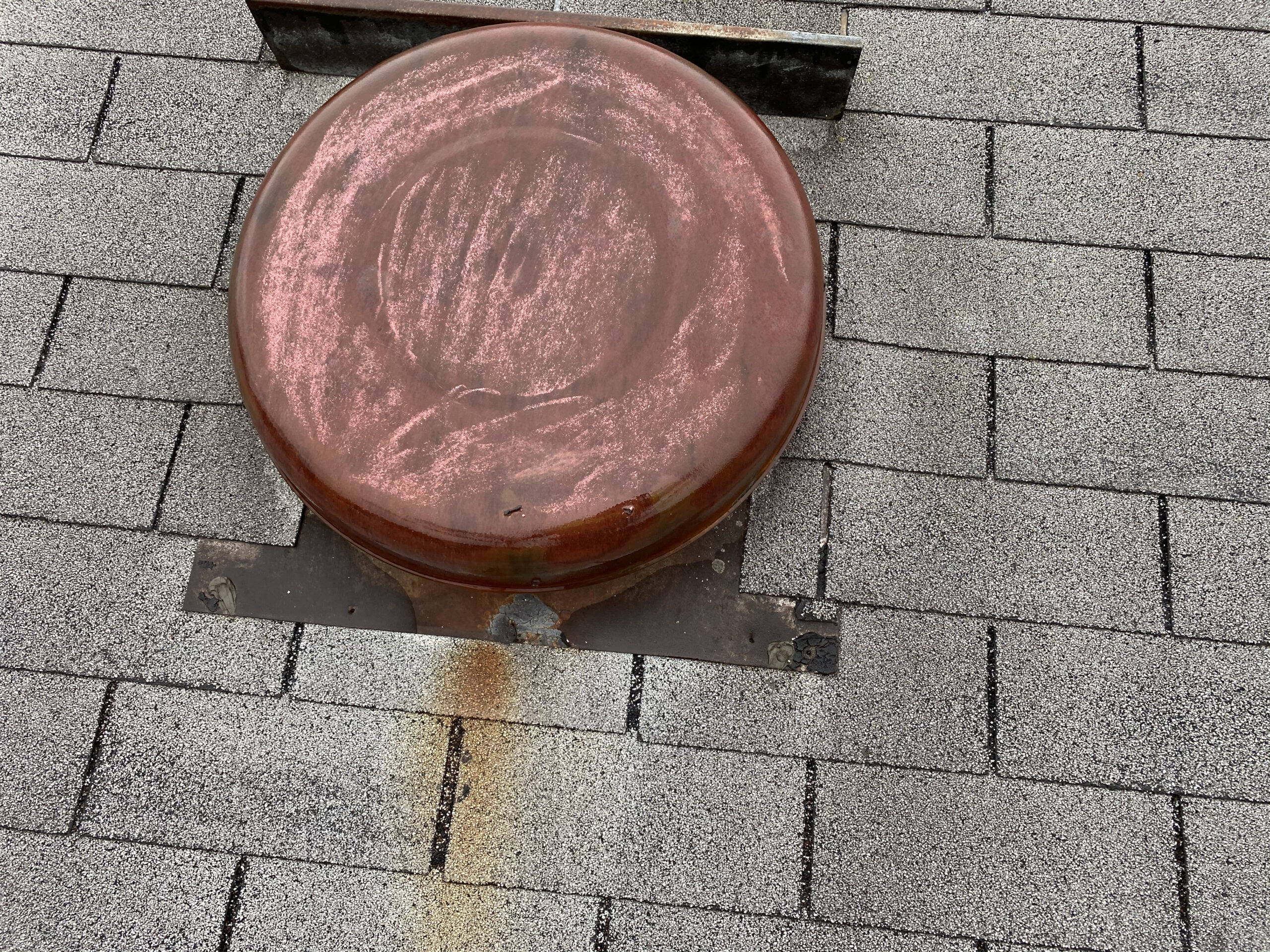 This is a picture of an old red roof vent