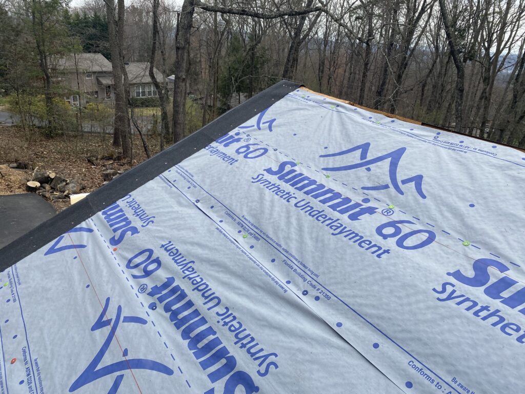 This is a picture of new atlas shingles being installed with synthetic underlayment.