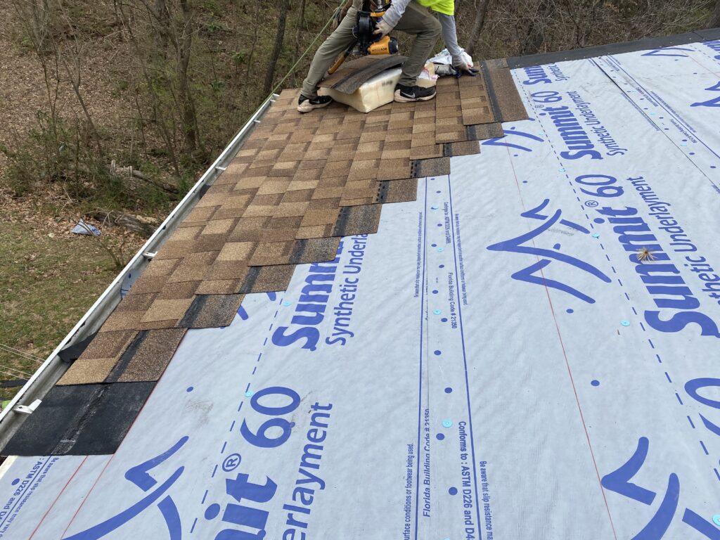 This is a picture of new atlas shingles being installed with synthetic underlayment.