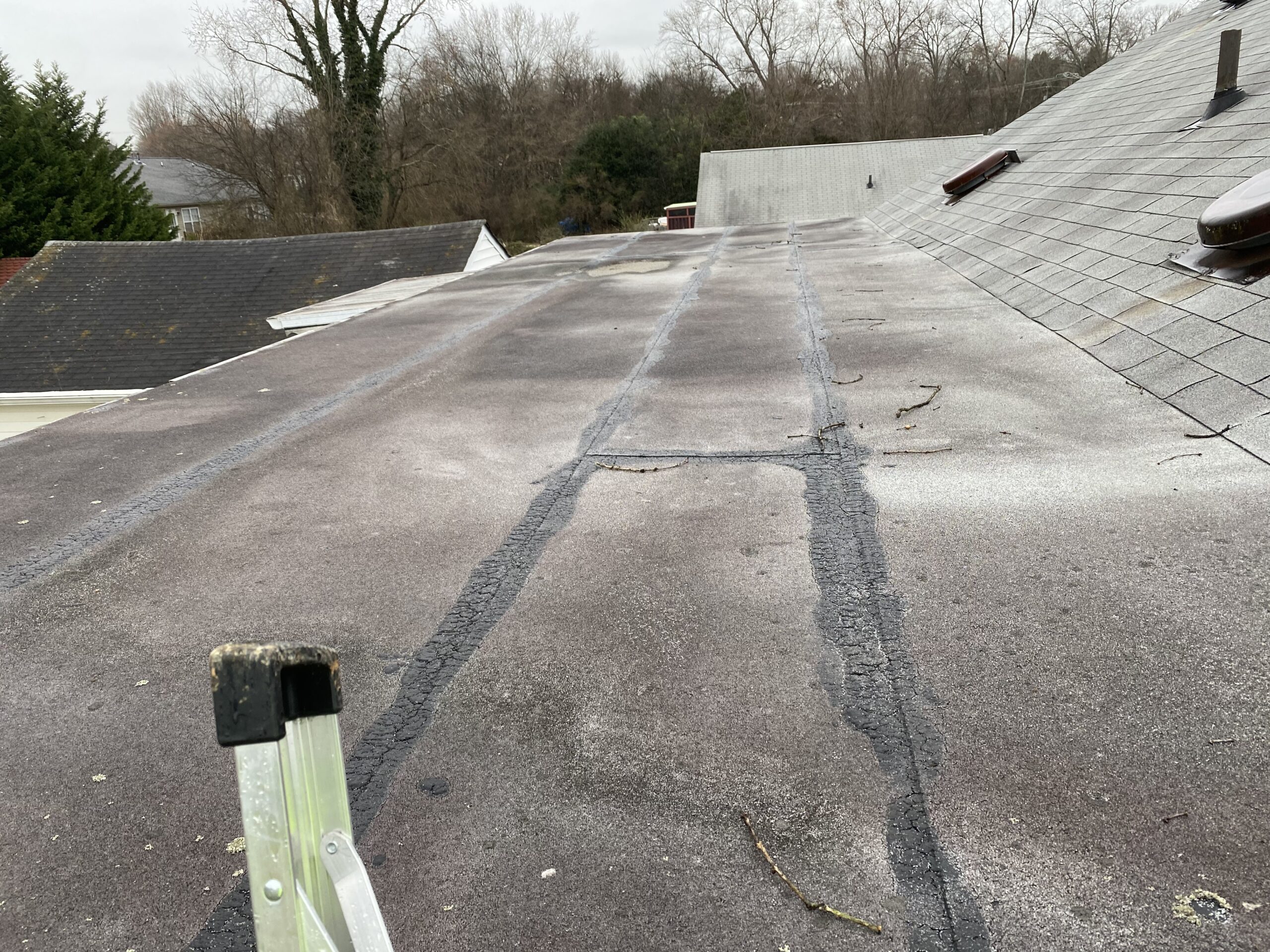 This is a picture of an old gray flat roof that needs TPO