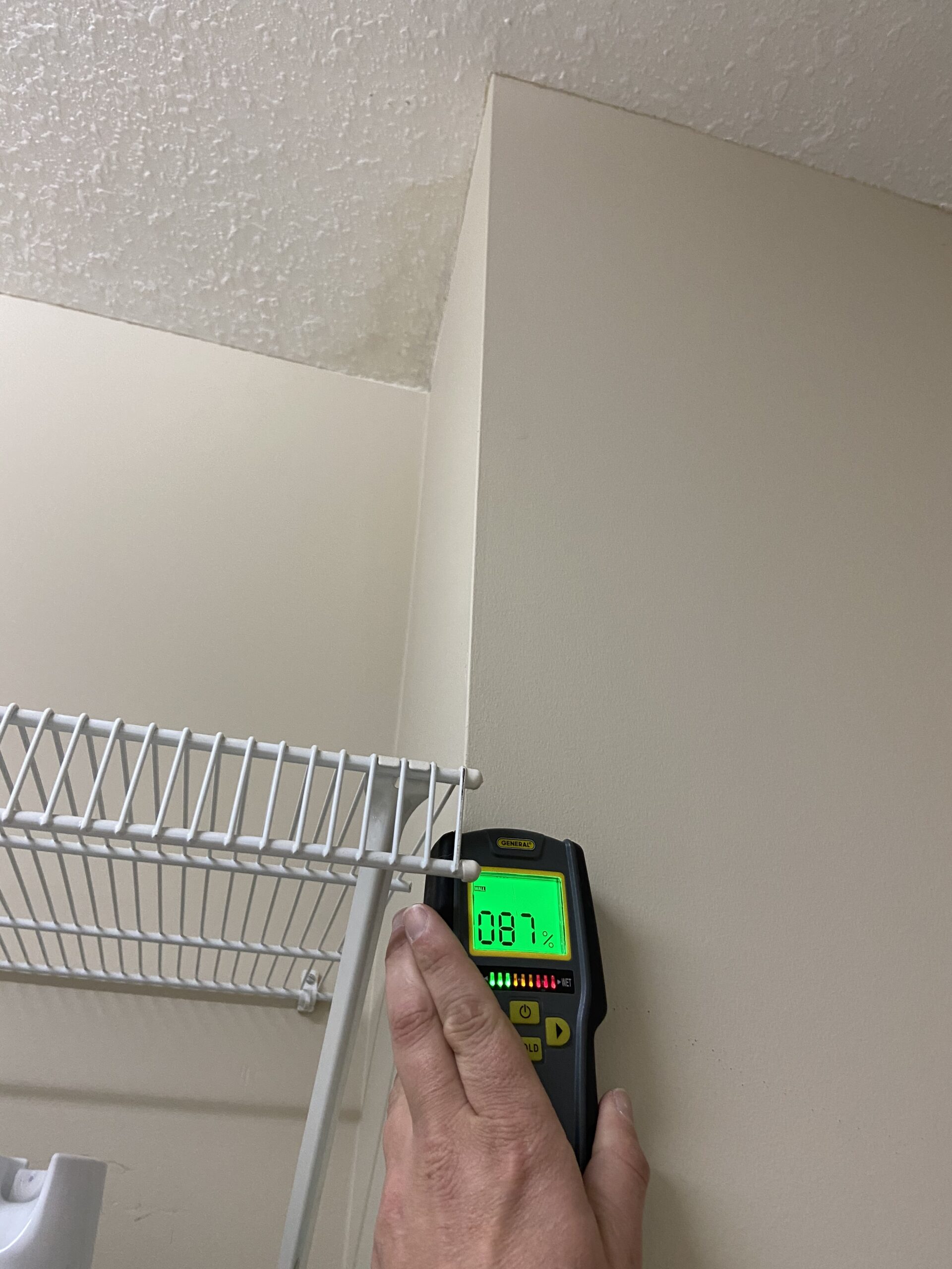 This is a picture of moisture meter inside of a home showing moisture in a wall