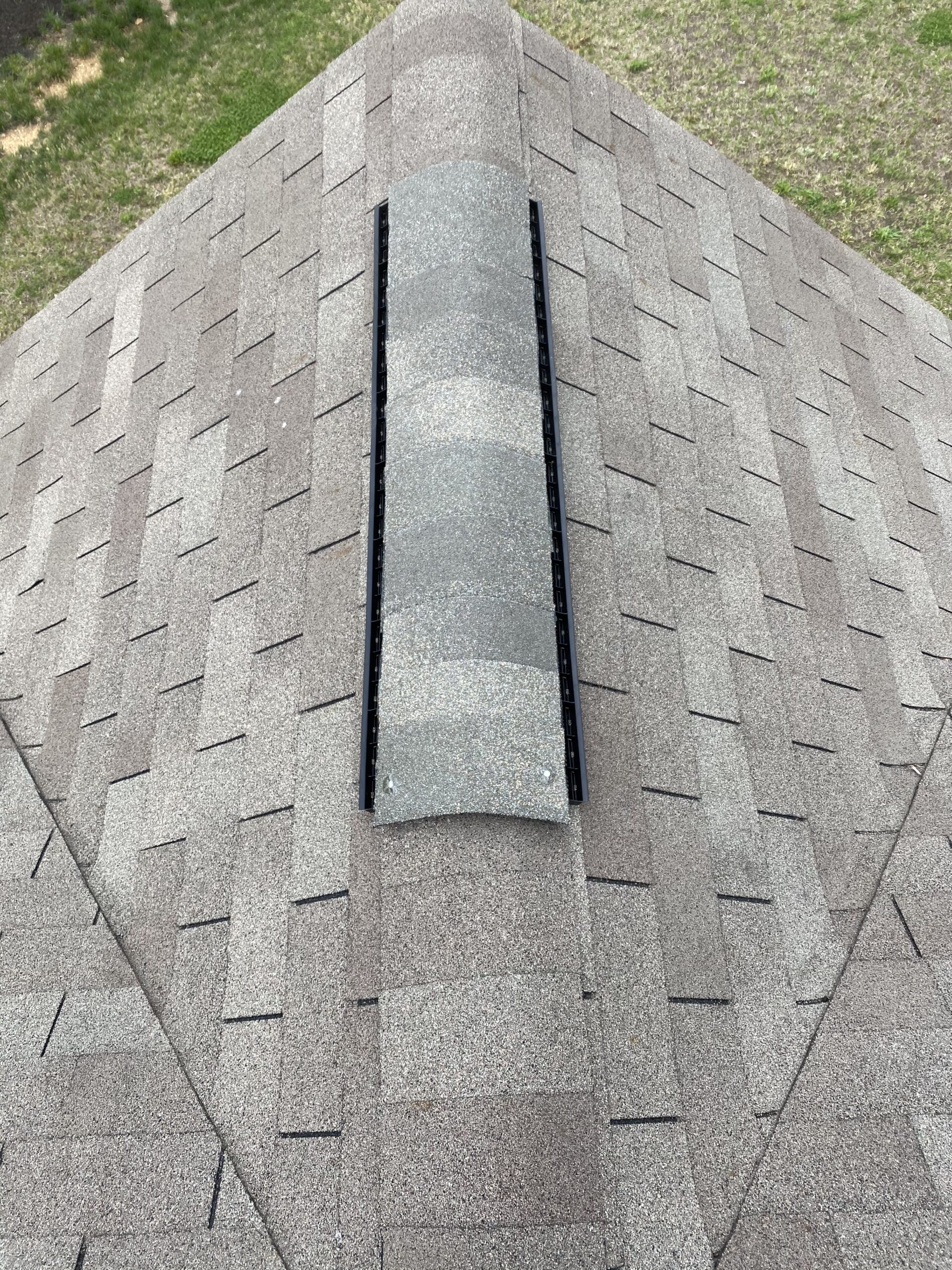 This is a picture of a new ridge vent with ridge cap shingles