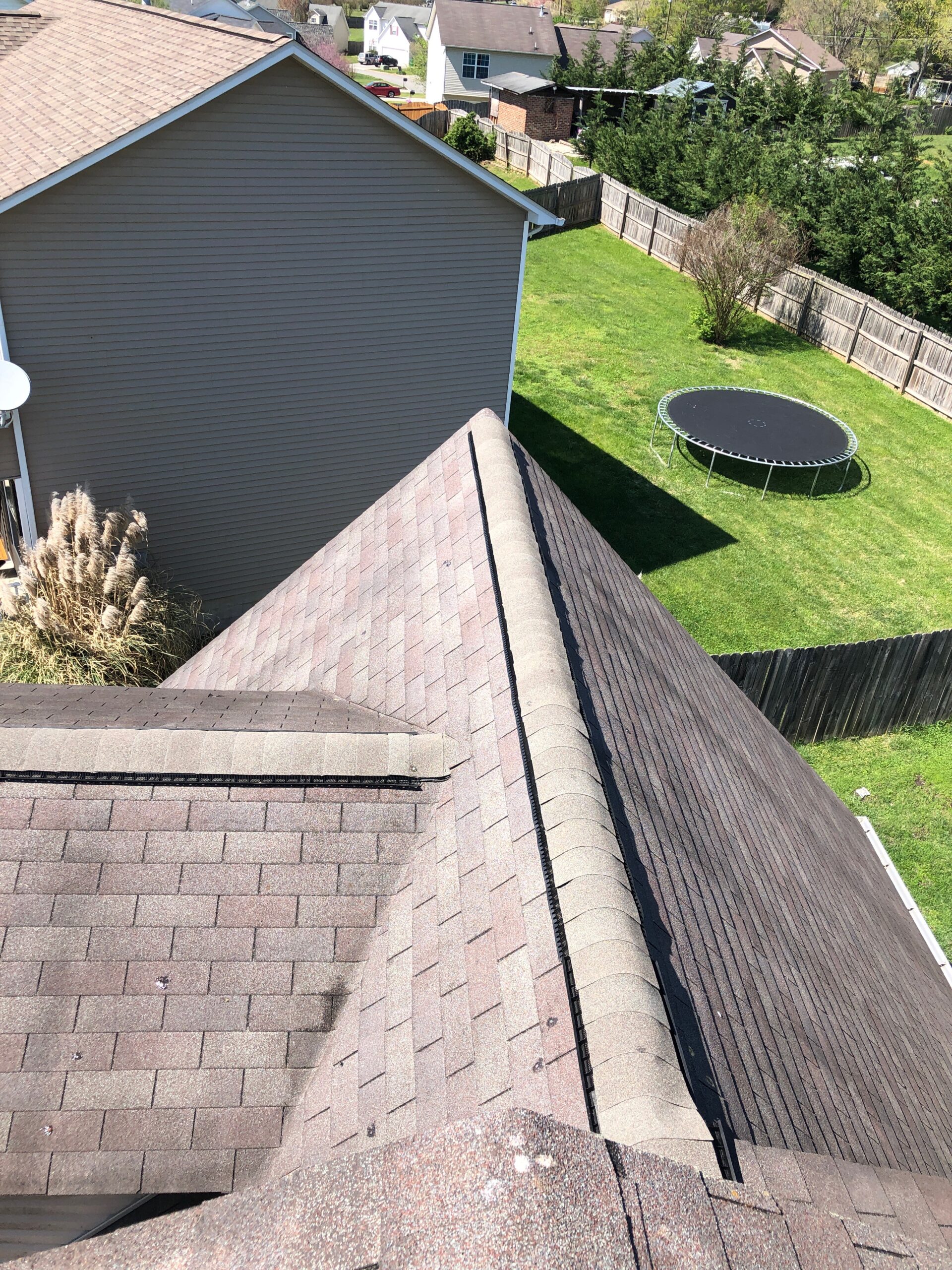 This is a picture of a ridge vent that is gray in color at the peak of the roof