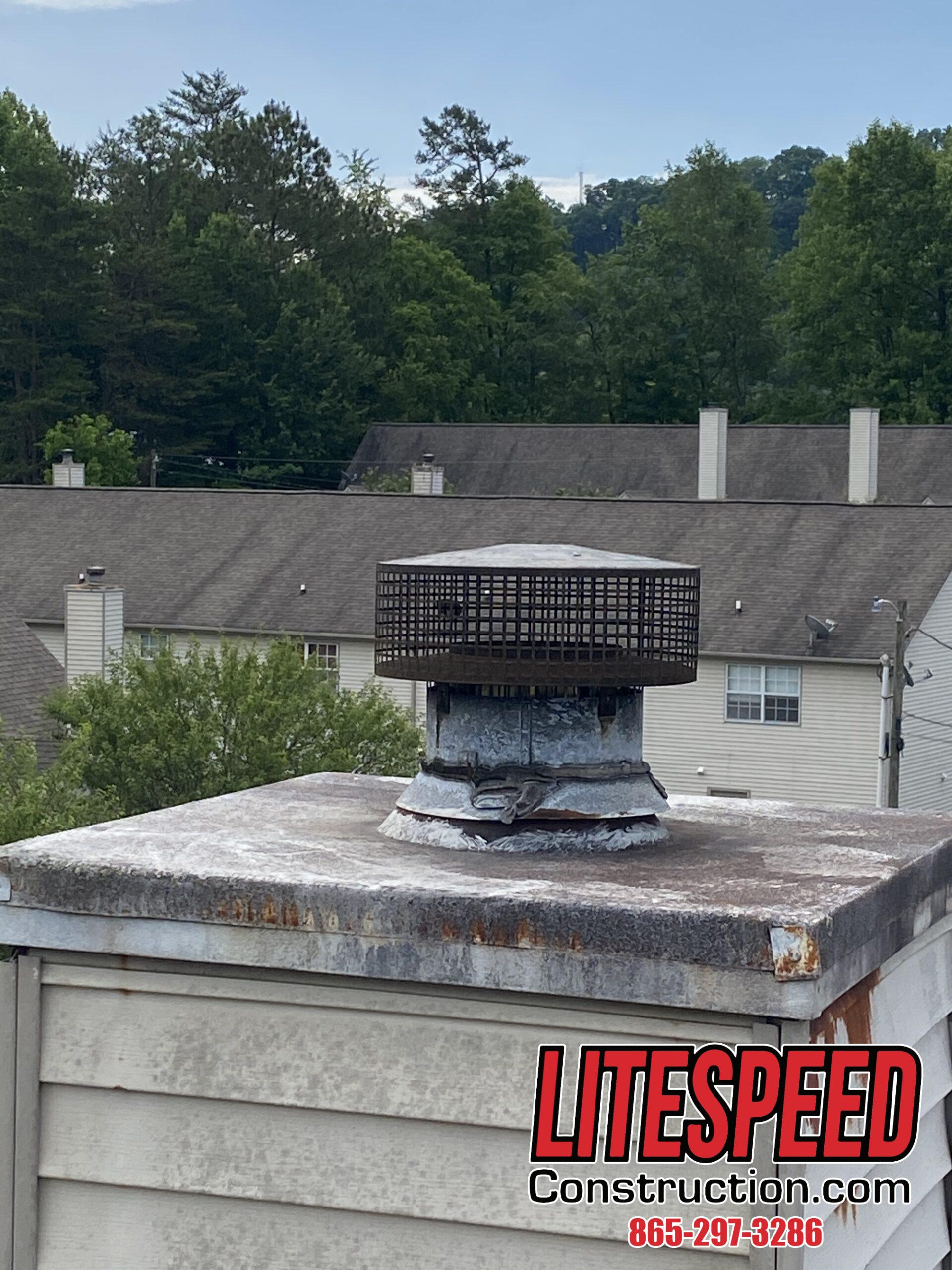 This is a picture of an old rusty chimney cap on a steep roof