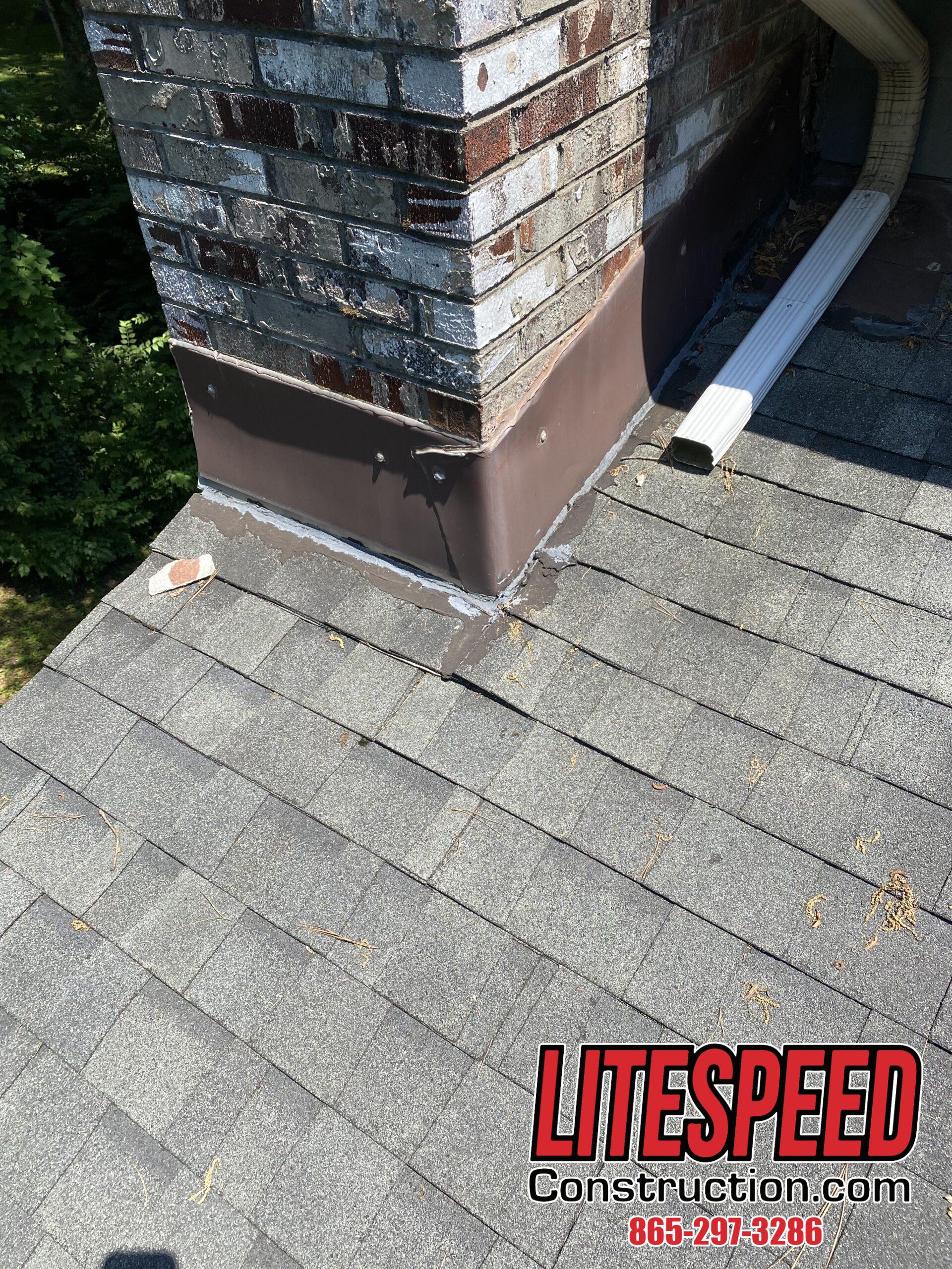 This is a picture of brow chimney flashing on a gray dimensional shingle roof