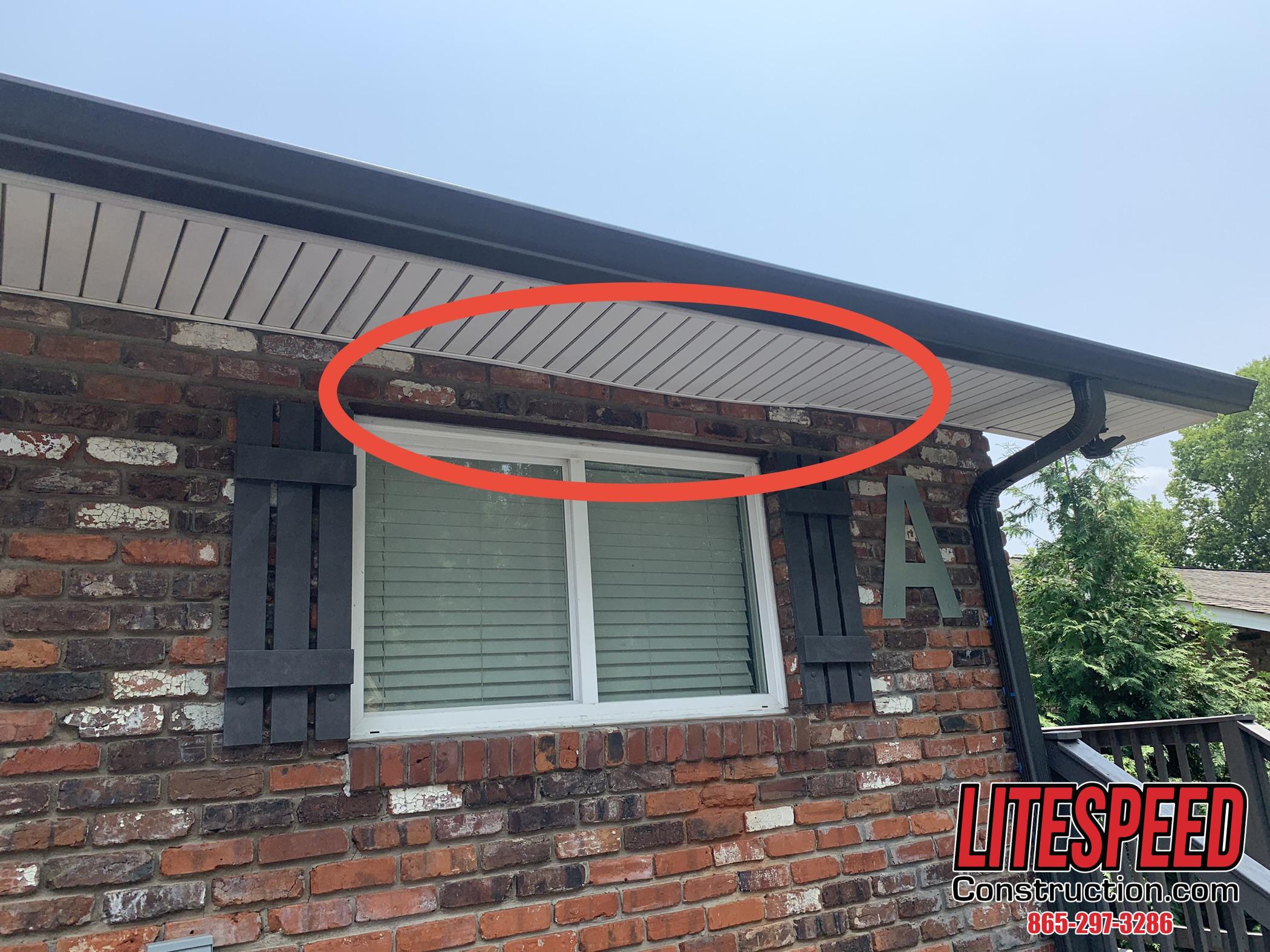 Repair and Replace Soffit in Knoxville TN This Vinyl Soffit Needs Repairs showing the warped piece of white vinyl