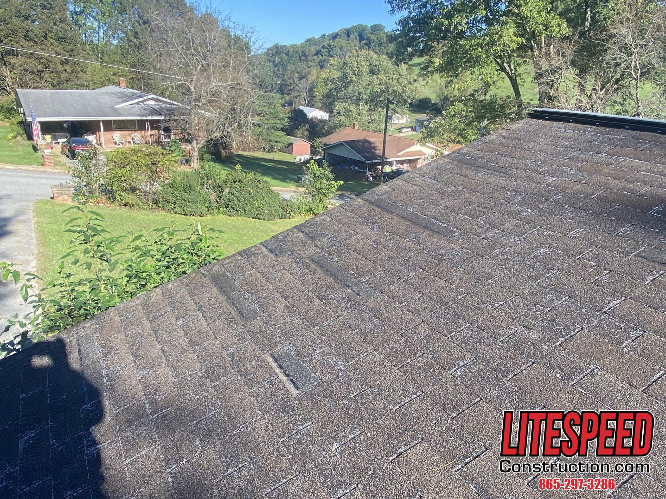 This is a picture of an old brown three tab roof with missing shingles