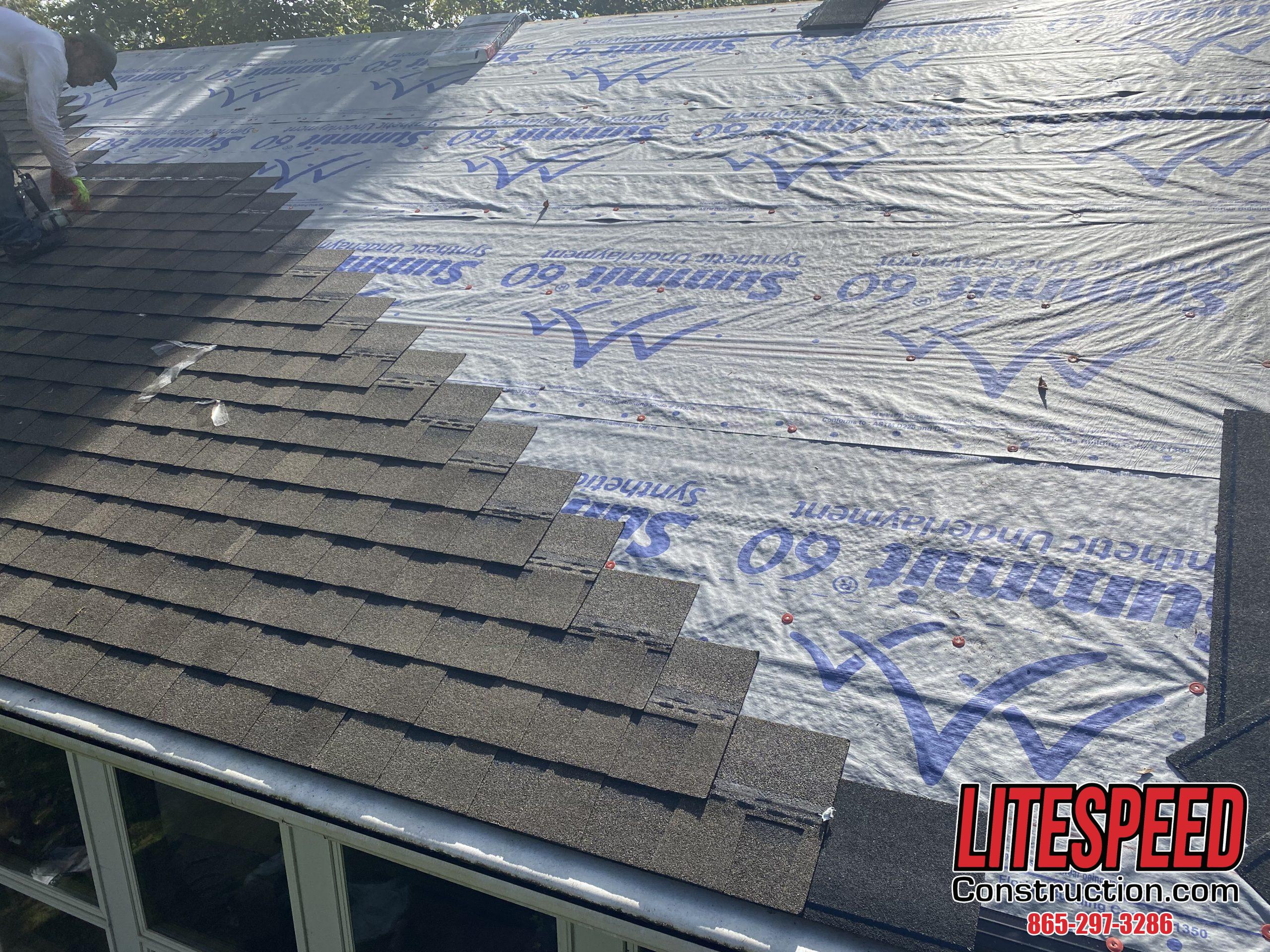 This is a picture of shingles being put on a roof with synthetic underlayment.