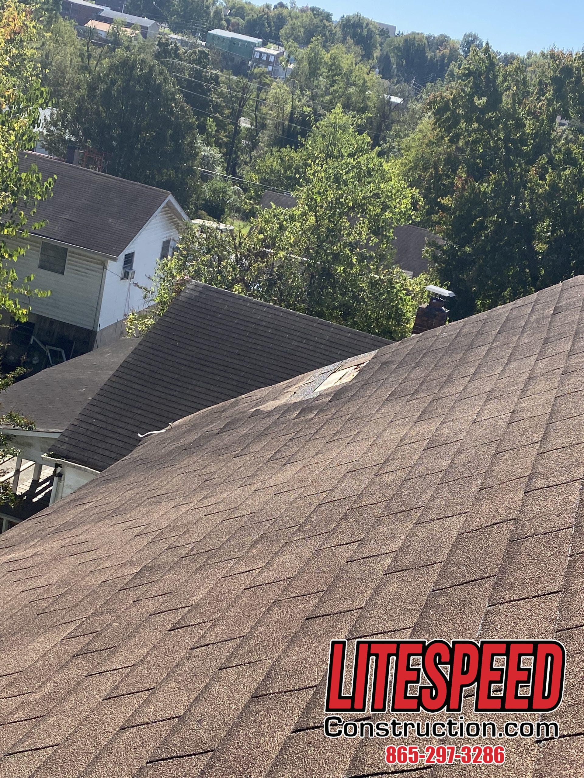 This is a picture of a brown three tab roof with missing shingles