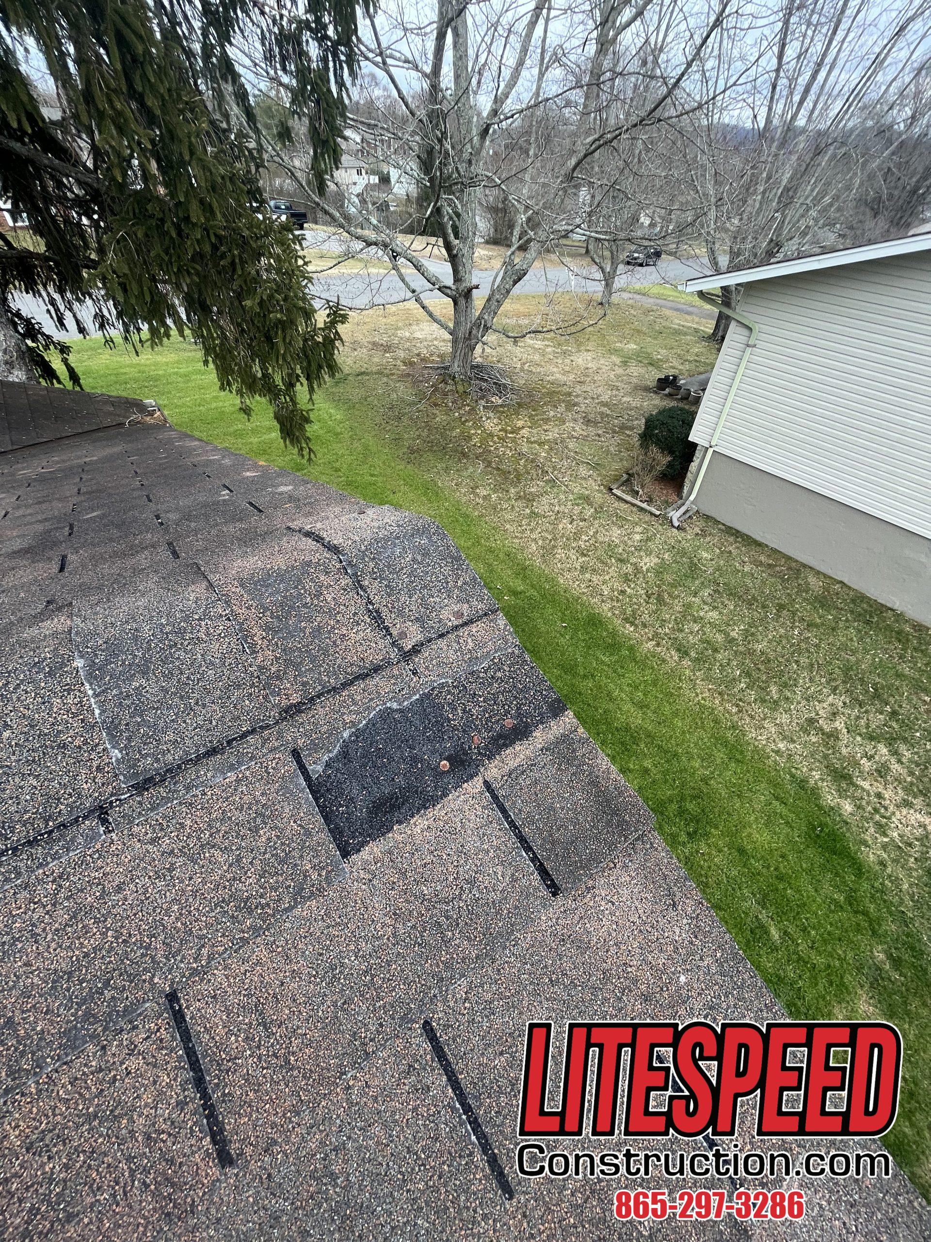 This is a picture of a brown three tab roof with missing tabs
