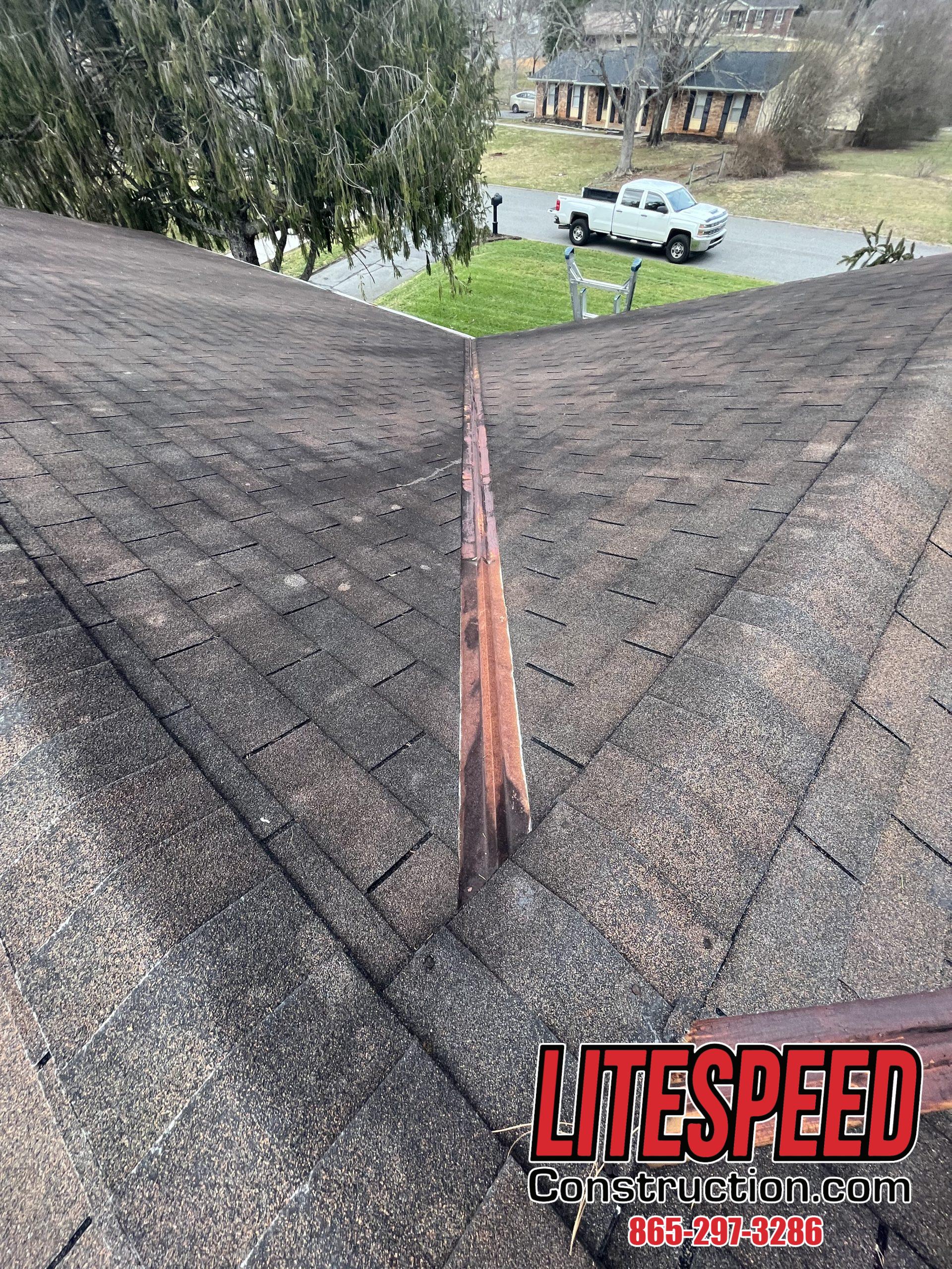 This is a picture of a valley on a brown three tab roof