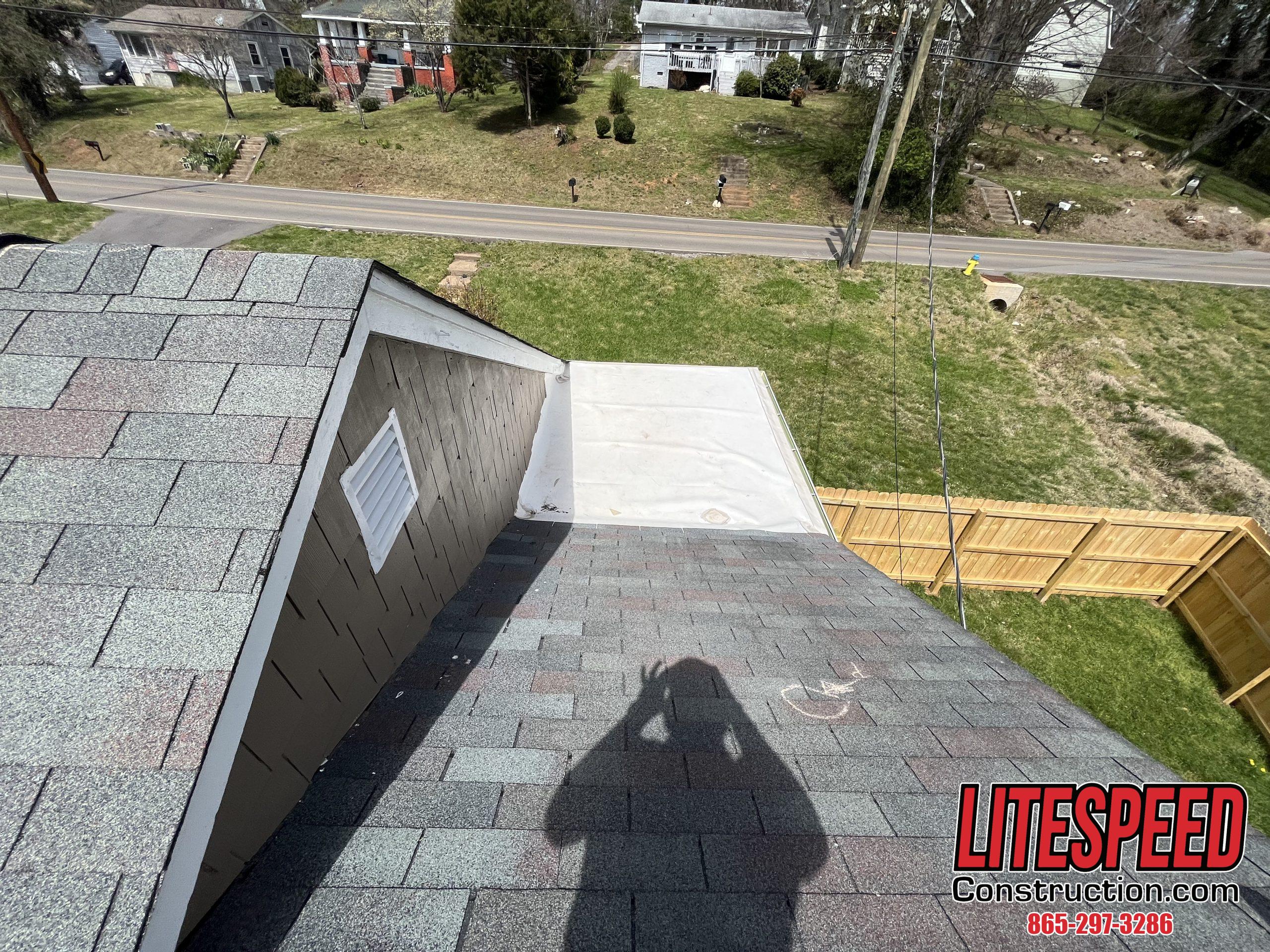 This is a picture of a flat roof that ties into a shingle roof 