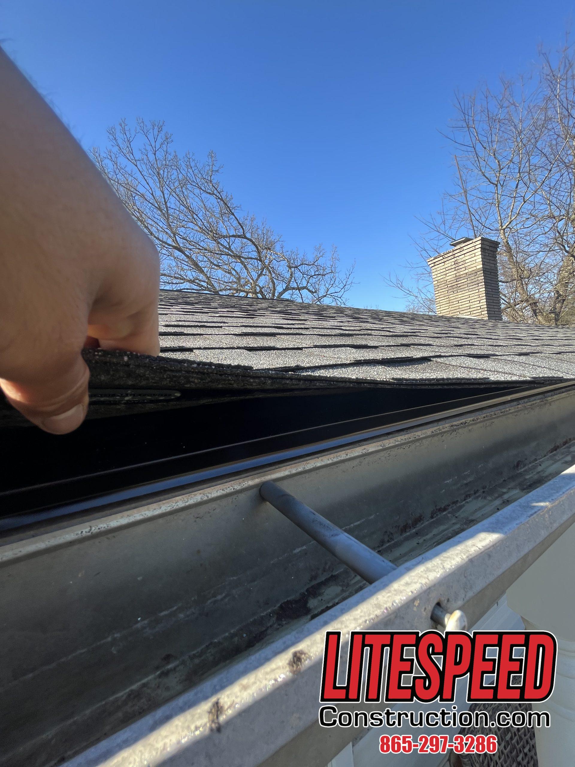 This is a picture of black drip edge on a gray shingle roof