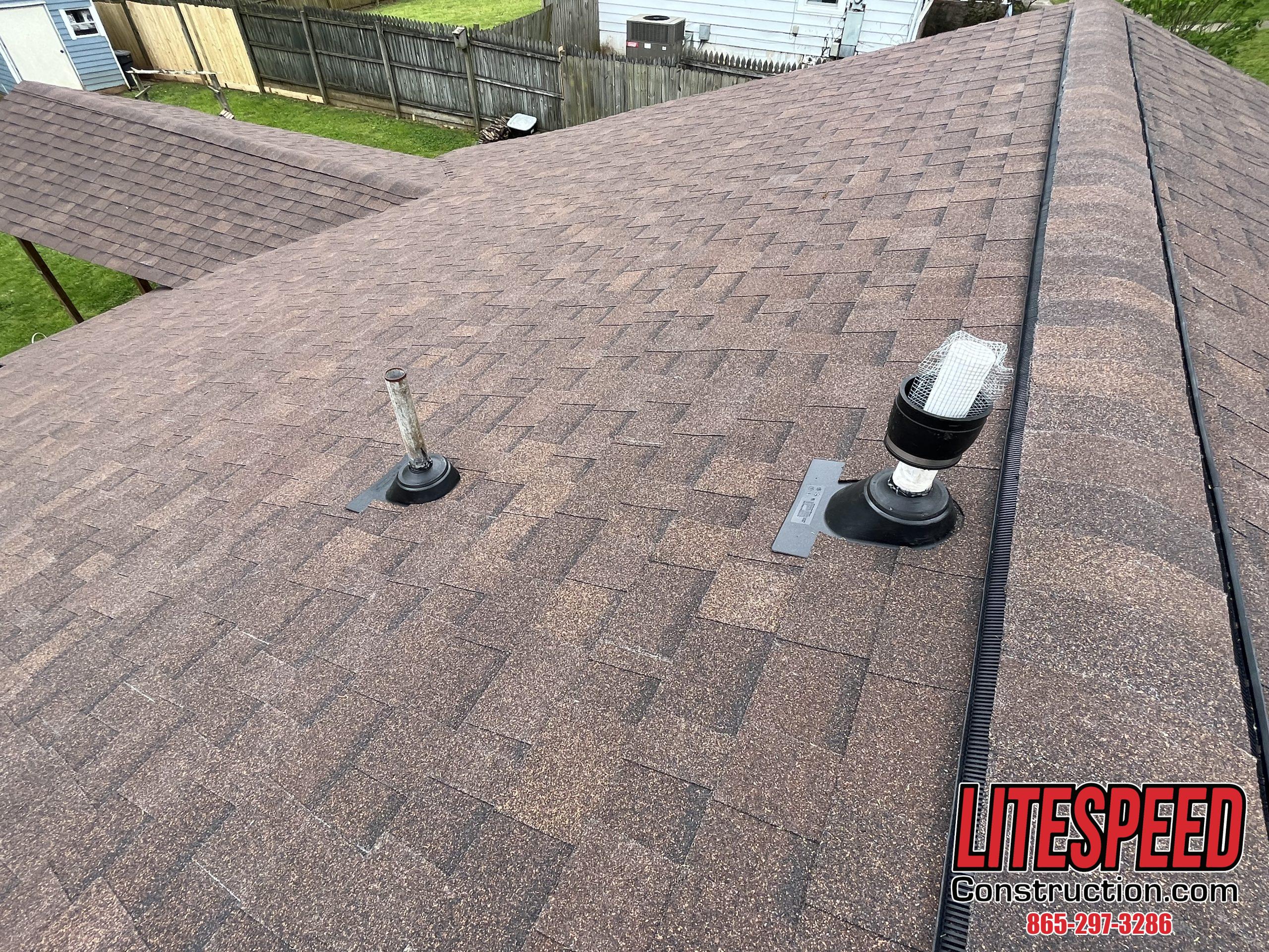 This is a picture of brown shingles with new pipe boots