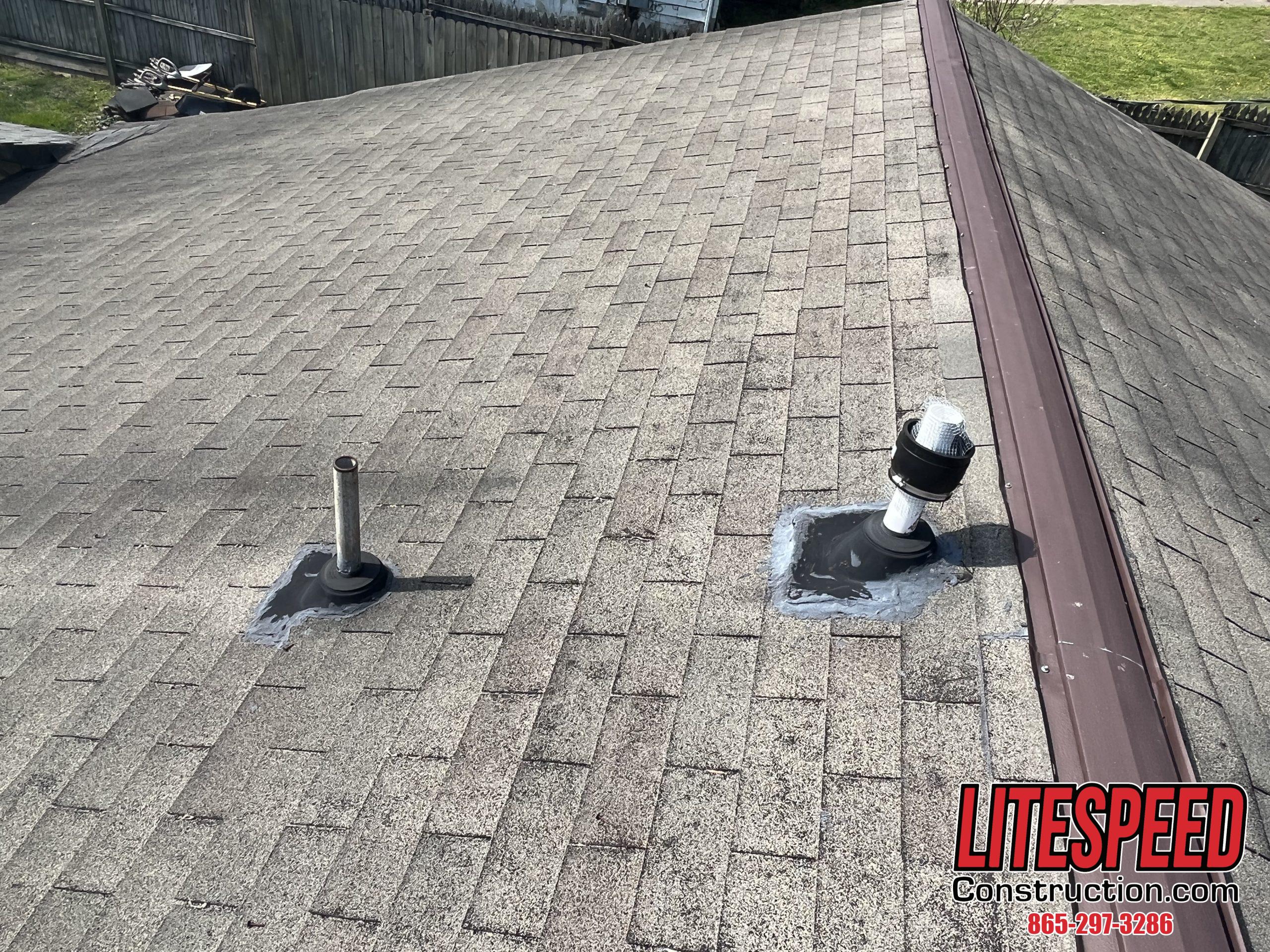 This is a picture of three tab shingles, bad pipe boots and metal ridge