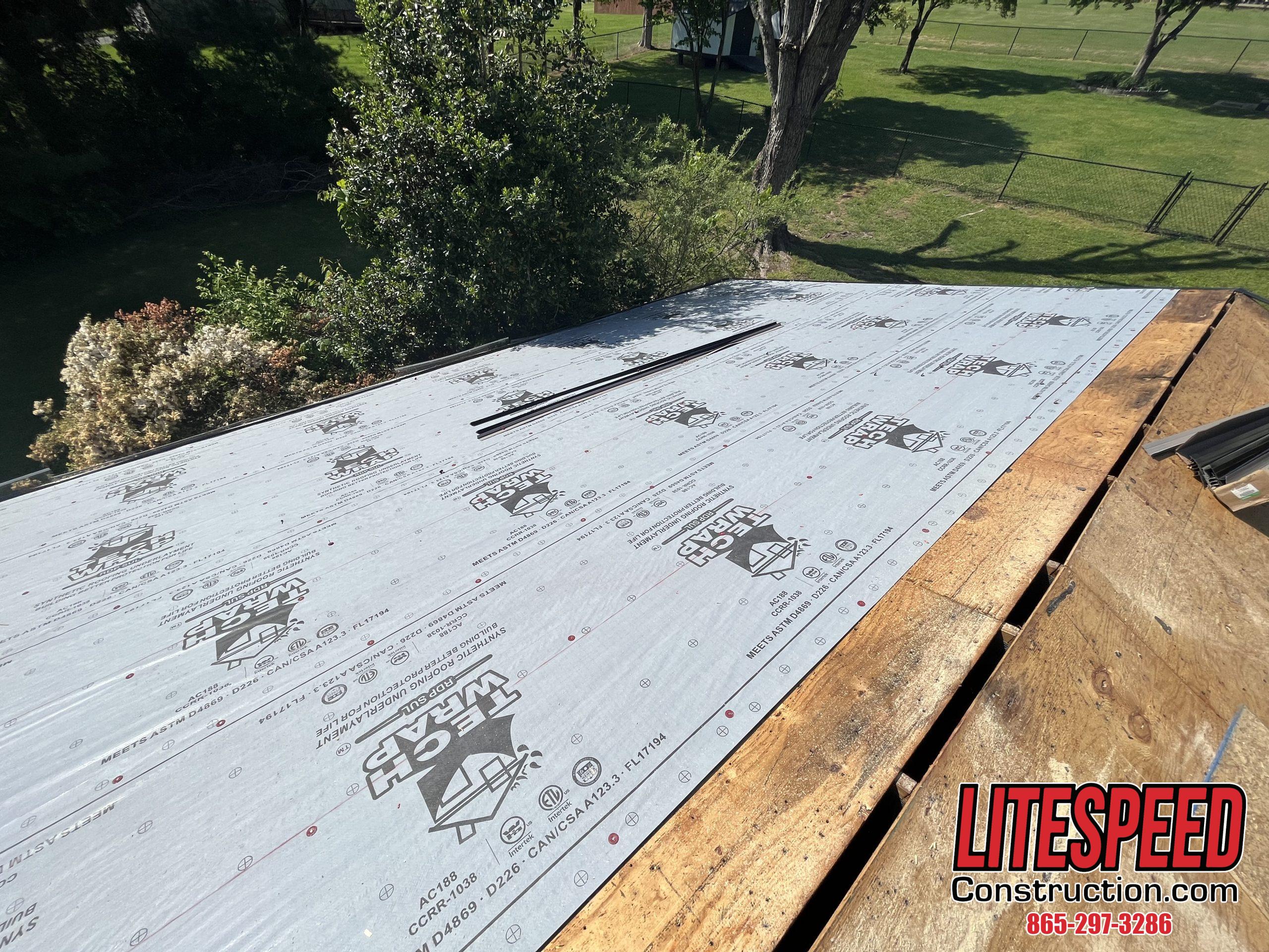 This is a picture of synthetic underlayment being laid down on a roof