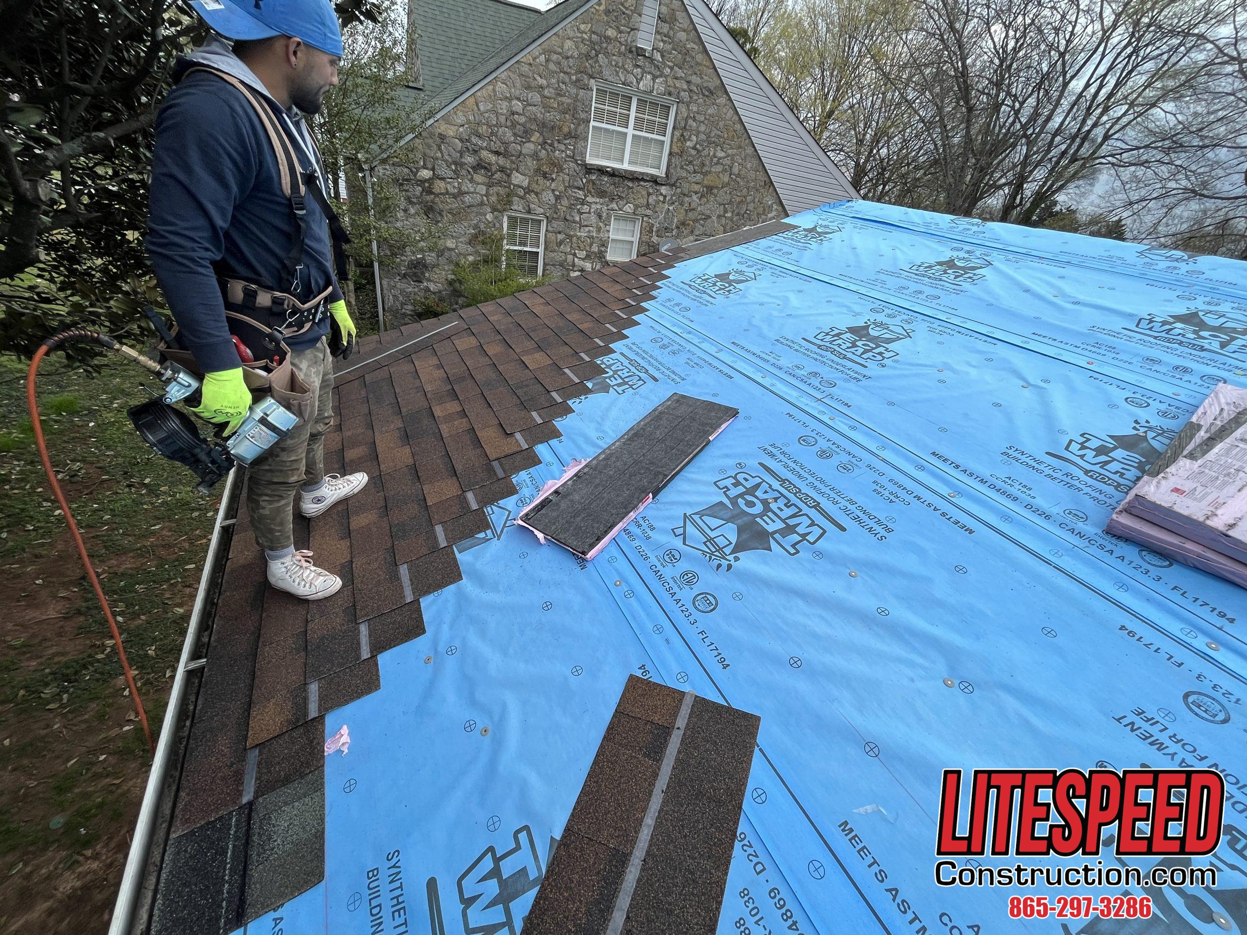 This is a picture of brown shingles being installed on a roof
