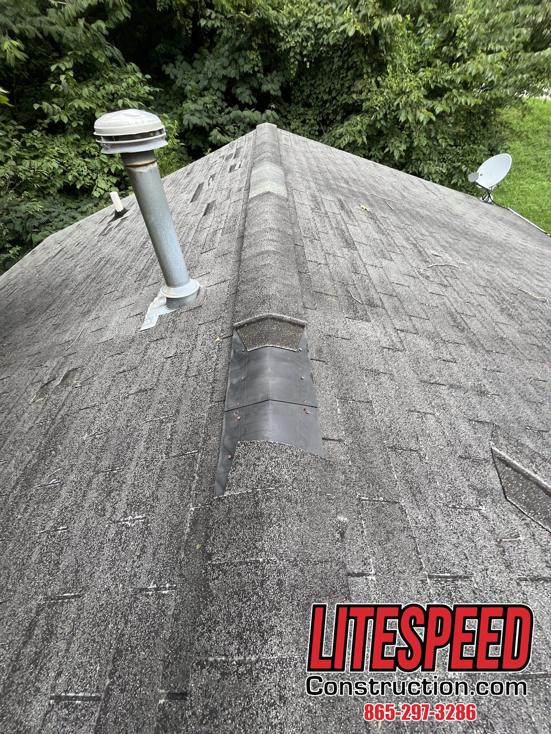 This is a picture of missing ridge cap shingles on a black roof