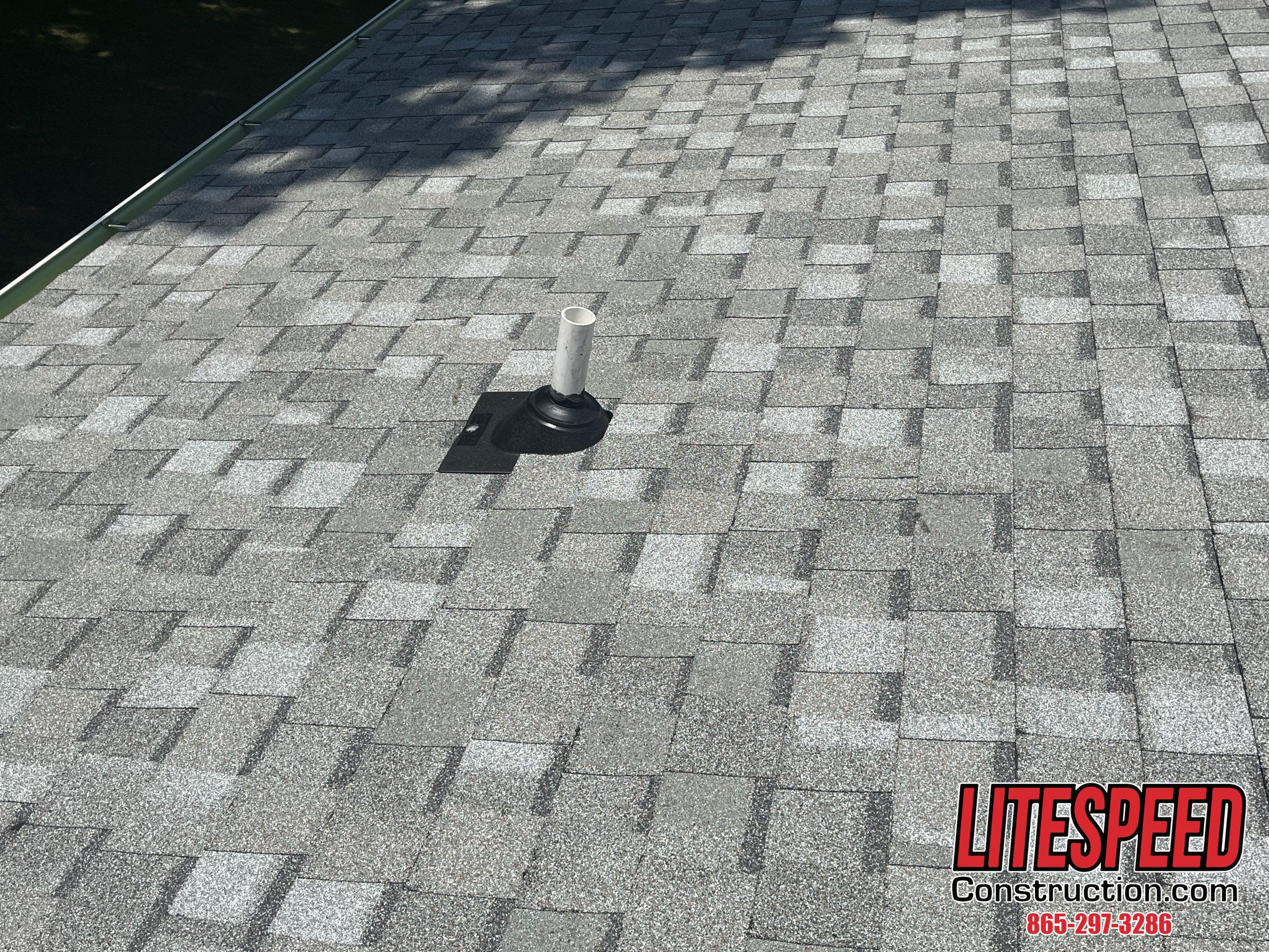 This is a picture of a new pipe boot on a light gray shingle roof